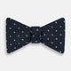 The Turnbull & Asser Lime Green and Sky Blue Spot Silk Bow Tie features a textured navy background with light blue and lime green polka dots, shown on a white background—a timeless men's accessory.