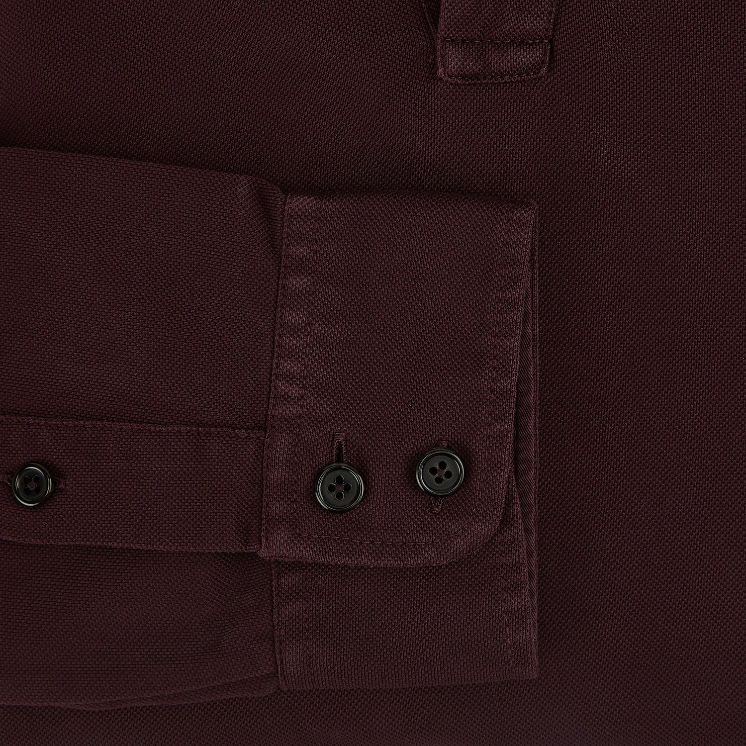 Image 4 of product The Turnbull & Asser Burgundy Rugby Polo Shirt is a long-sleeve, pure cotton collared top with no visible buttons, shown laid flat on a white background.
