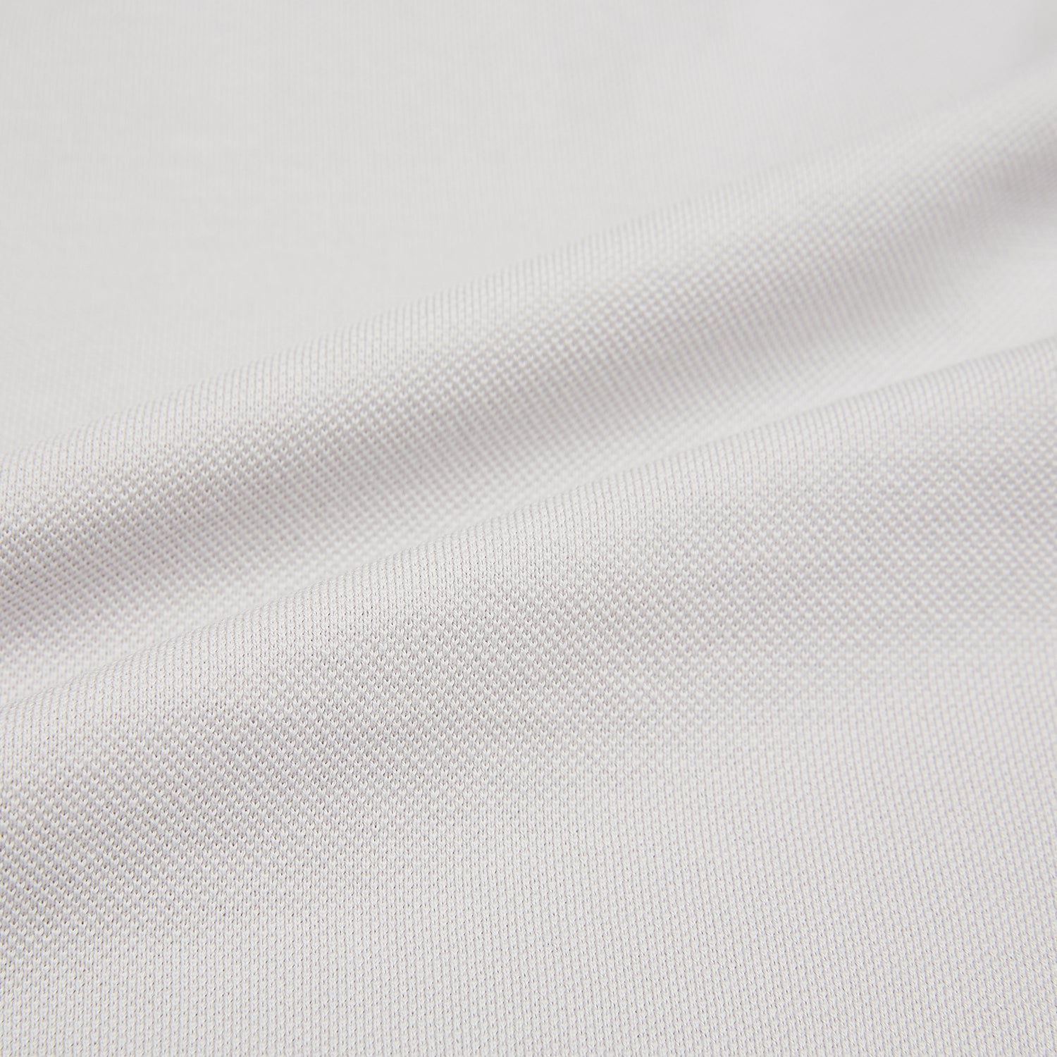 Image 5 of product The Turnbull & Asser Pale Pink Polo Shirt is a cotton jersey short-sleeve polo with a collar, three brown buttons on the placket, and a button-flap chest pocket, shown against a white background.