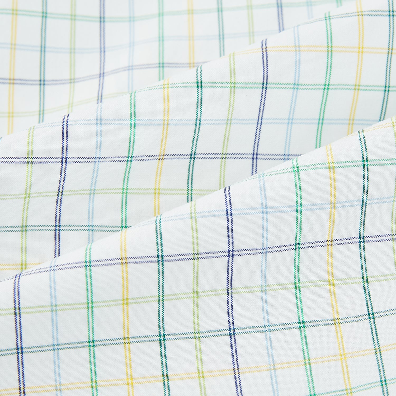 Image 6 of product The Turnbull & Asser Multi Tone Double Grid Check Mayfair Shirt is a long-sleeve, button-up with a classic collar, showcasing pure cotton light blue, green, and yellow grid checks on white, neatly displayed flat against a white surface.