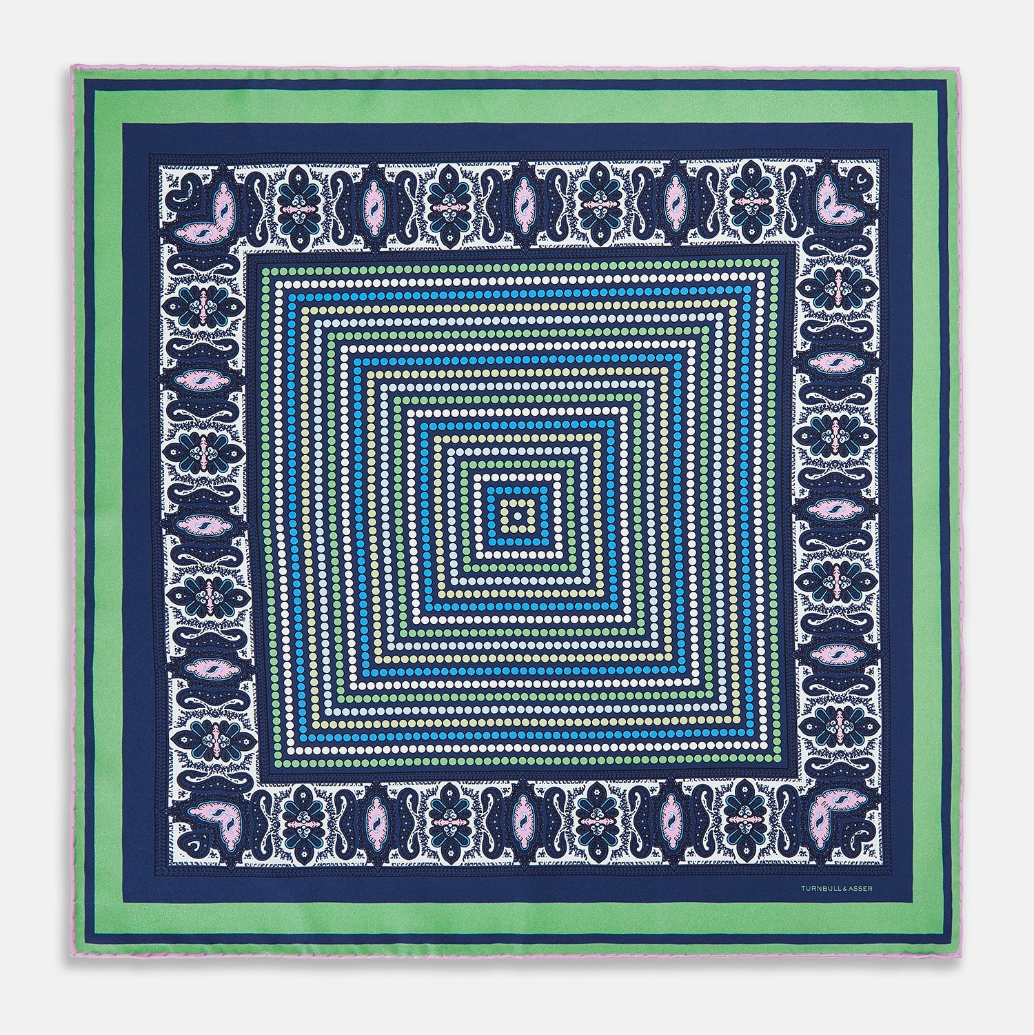 Image 9 of product The Turnbull & Asser Oxford Blue Dots and Paisley Silk Pocket Square is handcrafted in England and features a blue, green, and white polka dot pattern with a paisley and floral border, plus the brand’s signature logo in the corner.