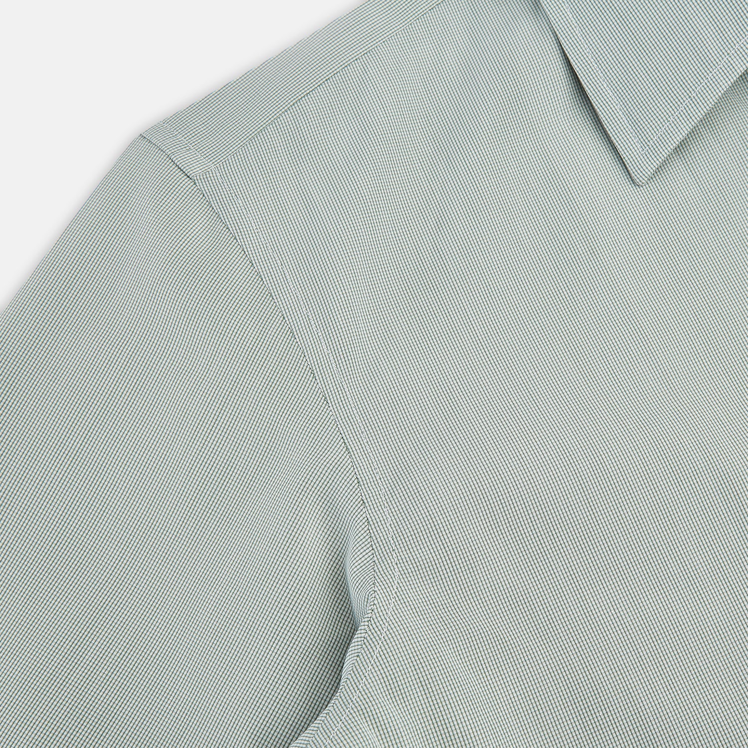 Image 6 of product A dark green micro graph check Westminster shirt by Turnbull & Asser, featuring fine British craftsmanship, a Turnbull collar, and white buttons, is laid flat on a white background.