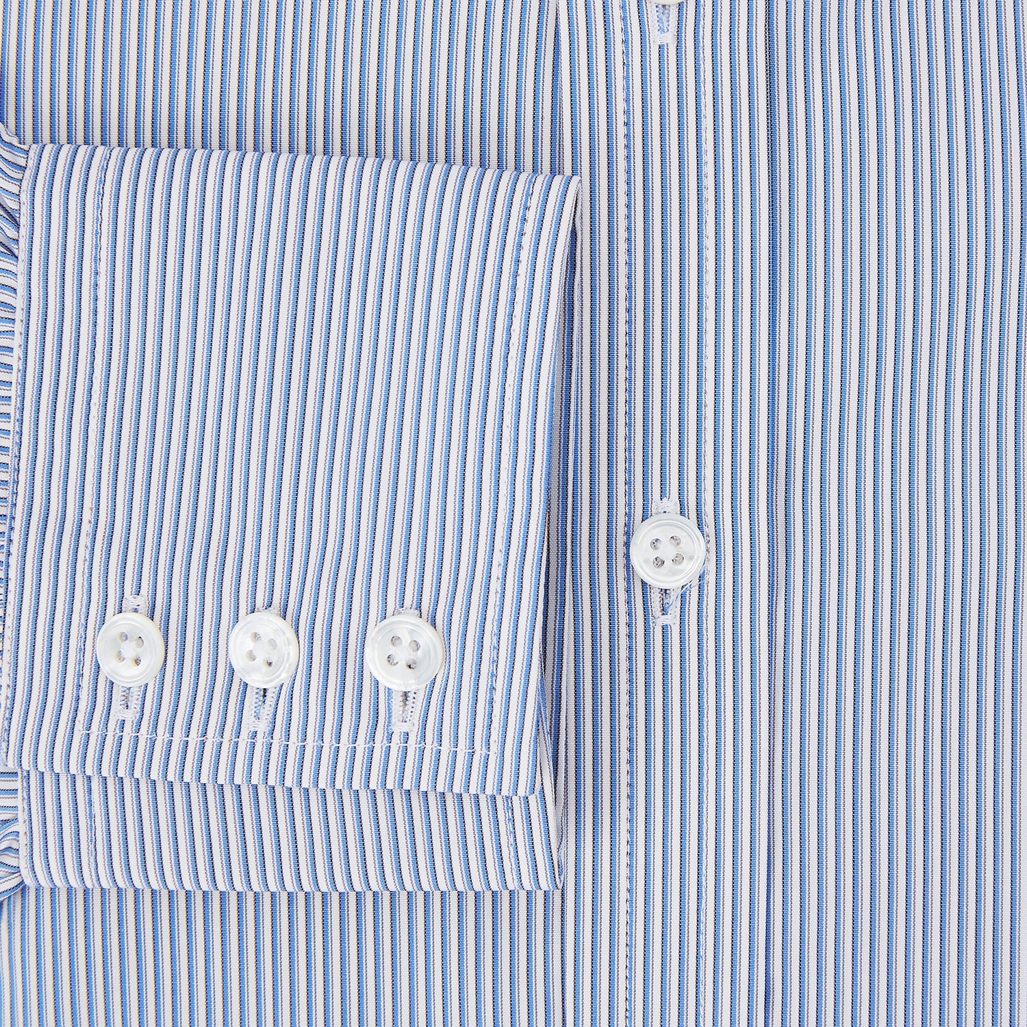 Image 4 of product The Turnbull & Asser Pale Blue Pinstripe Mayfair Shirt features pale blue pinstripes, a classic T&A collar, white buttons, and cuffed sleeves, shown against a plain white background.