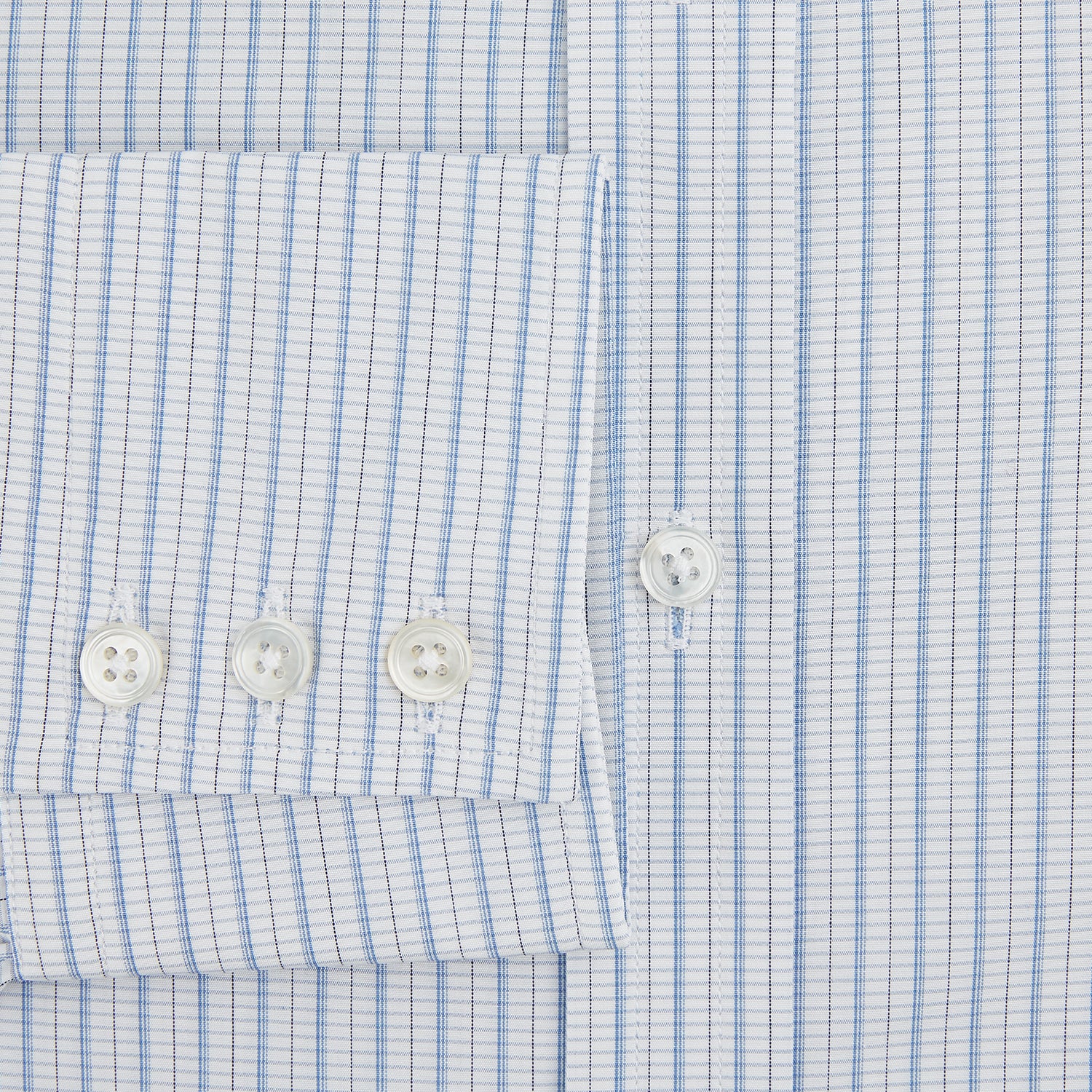 Image 4 of product The Turnbull & Asser Blue Graph Check Mayfair Shirt features a classic T&A collar, Mayfair fit, buttoned cuffs, and long sleeves with light blue graph checks on a white background.