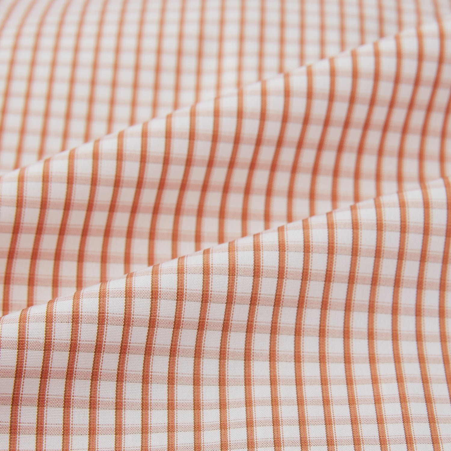 Image 6 of product The Orange Micro Shadow Check Mayfair Shirt by Turnbull & Asser features a T&A collar, button-down front, and buttoned cuffs; crafted from Italian cotton in an orange and white check pattern, laid flat on a white background.