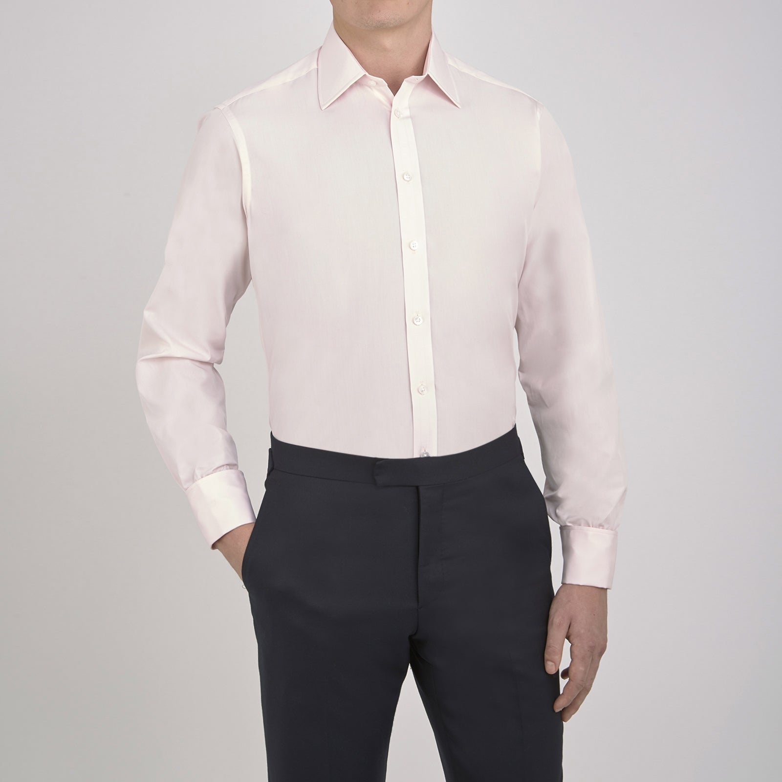 Image 4 of product A neatly folded Pink Cotton Shirt with T&A collar and double cuffs by Turnbull & Asser, featuring a classic design with white buttons and an inner label, displayed on a plain white background.