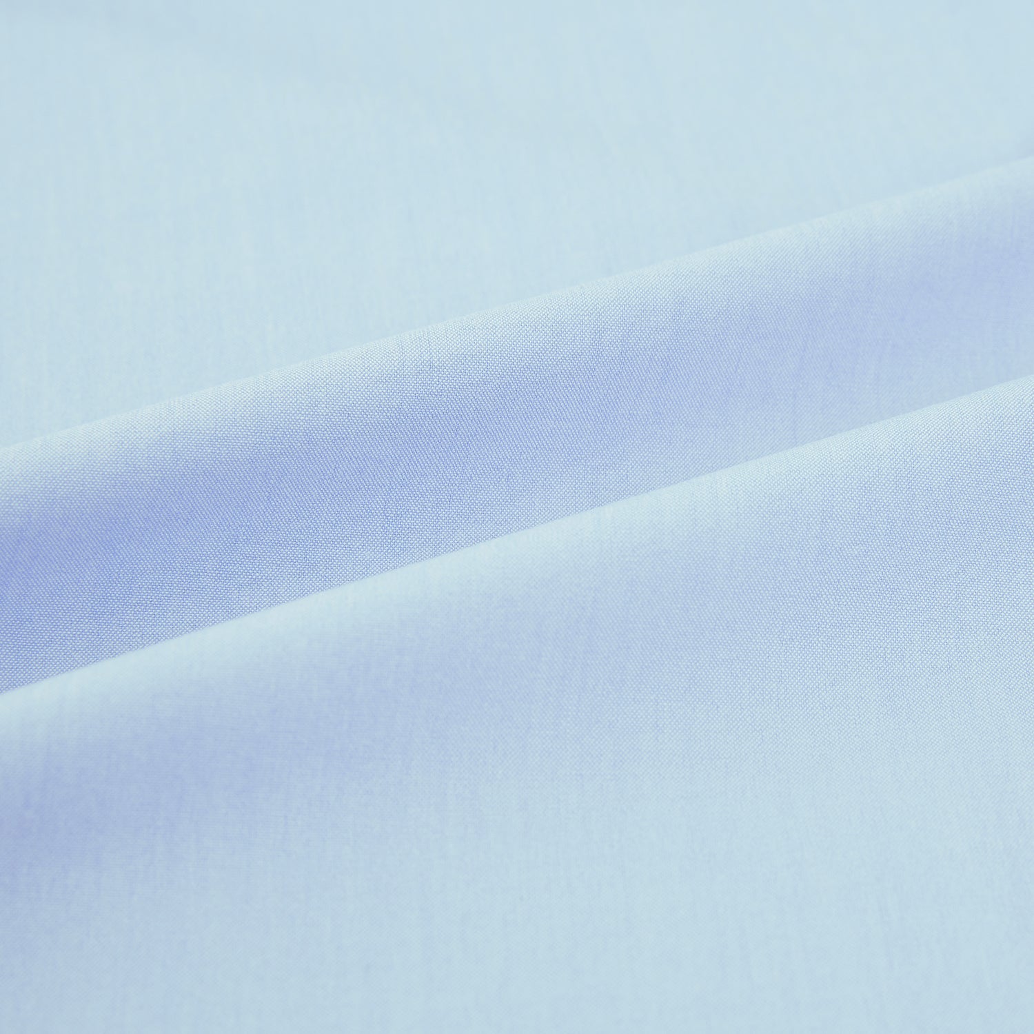 Image 6 of product The Turnbull & Asser Sky Blue Mayfair Shirt is a long-sleeved, collared button-down made from sanforised cotton, shown laid flat on a white background.