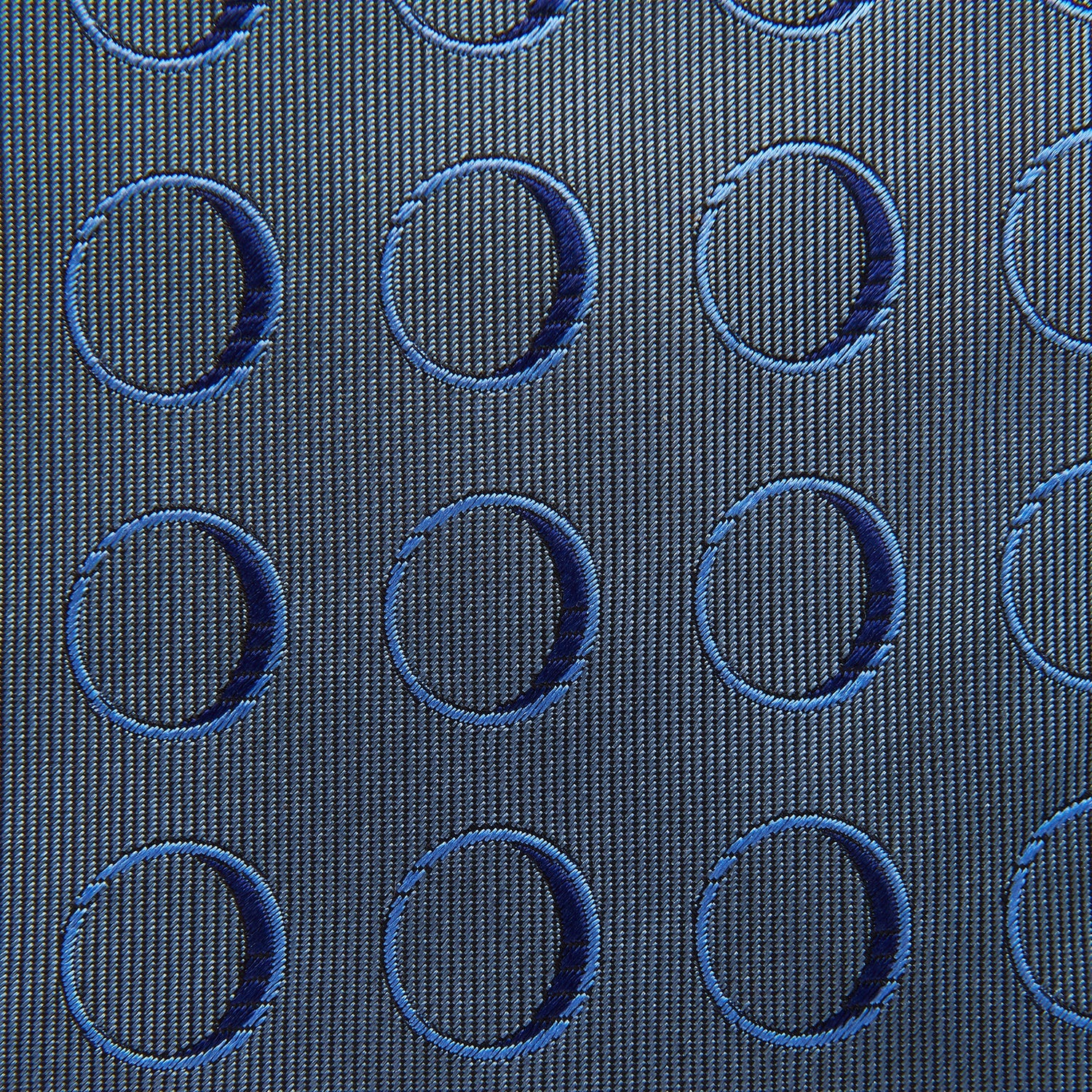 Image 4 of product The Turnbull & Asser Die Another Day Circle Silk Tie, as seen on James Bond, features large dark blue ovals on a lighter blue background.