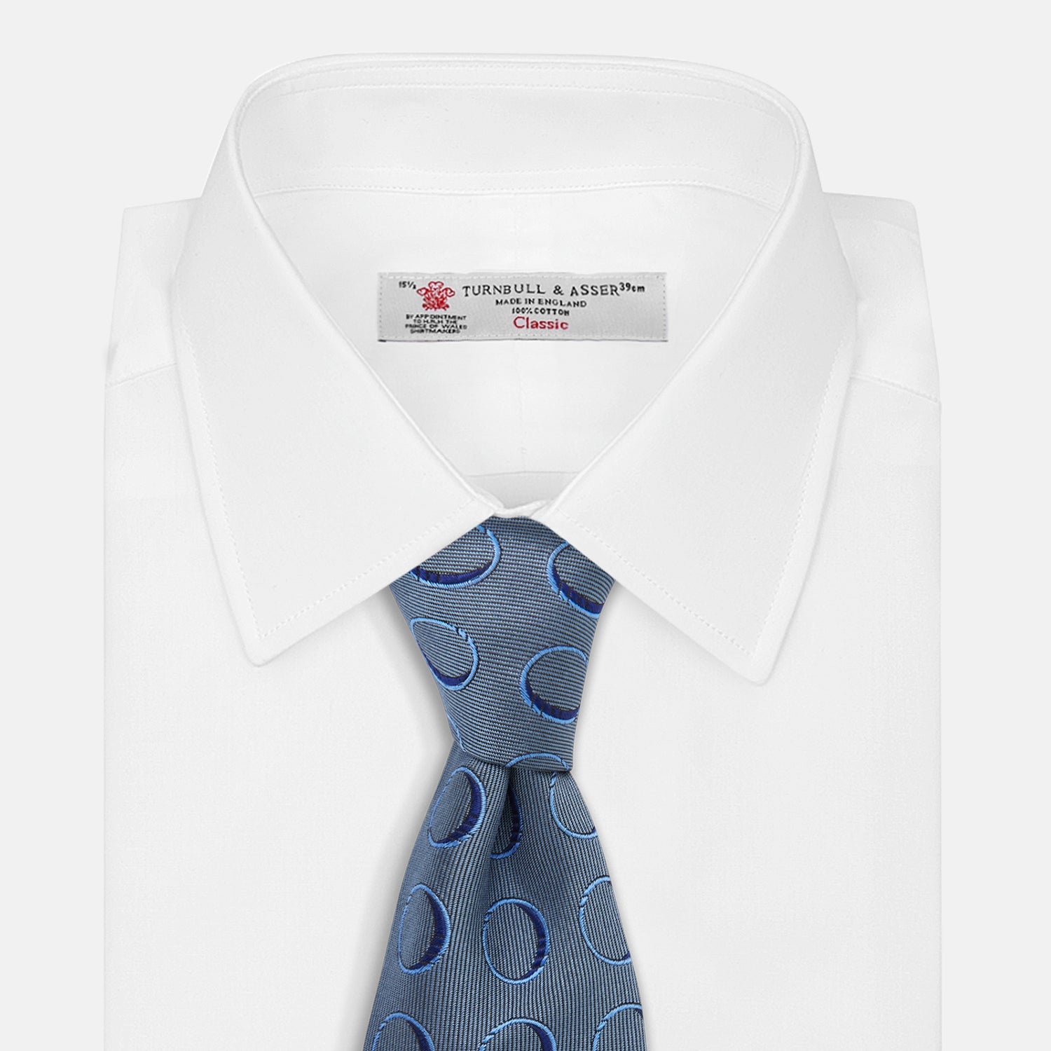 Image 3 of product The Turnbull & Asser Die Another Day Circle Silk Tie, as seen on James Bond, features large dark blue ovals on a lighter blue background.
