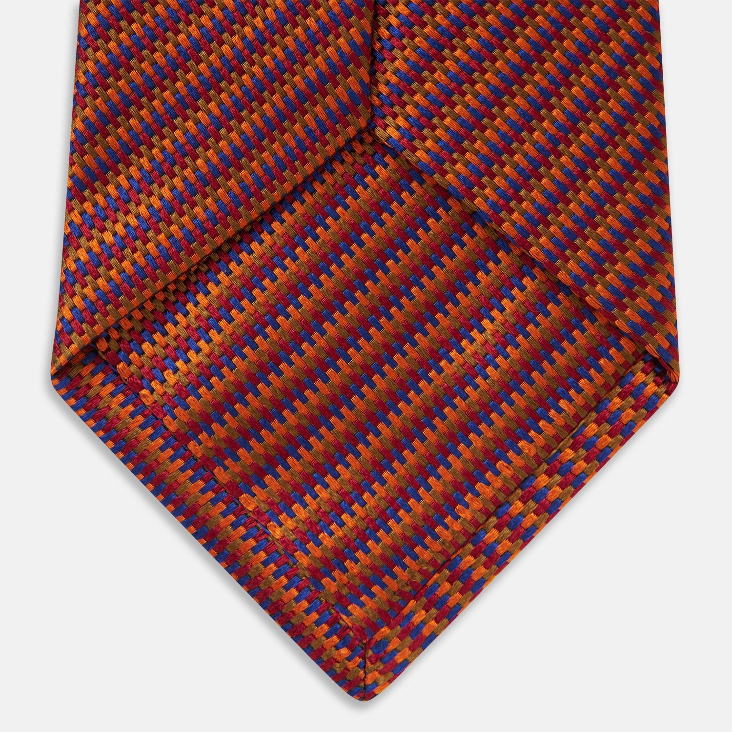Image 5 of product The Turnbull & Asser Die Another Day Stripe Silk Tie, as seen on James Bond, showcases a vibrant orange, red, and purple woven pattern, elegantly rolled and displayed against a white background.