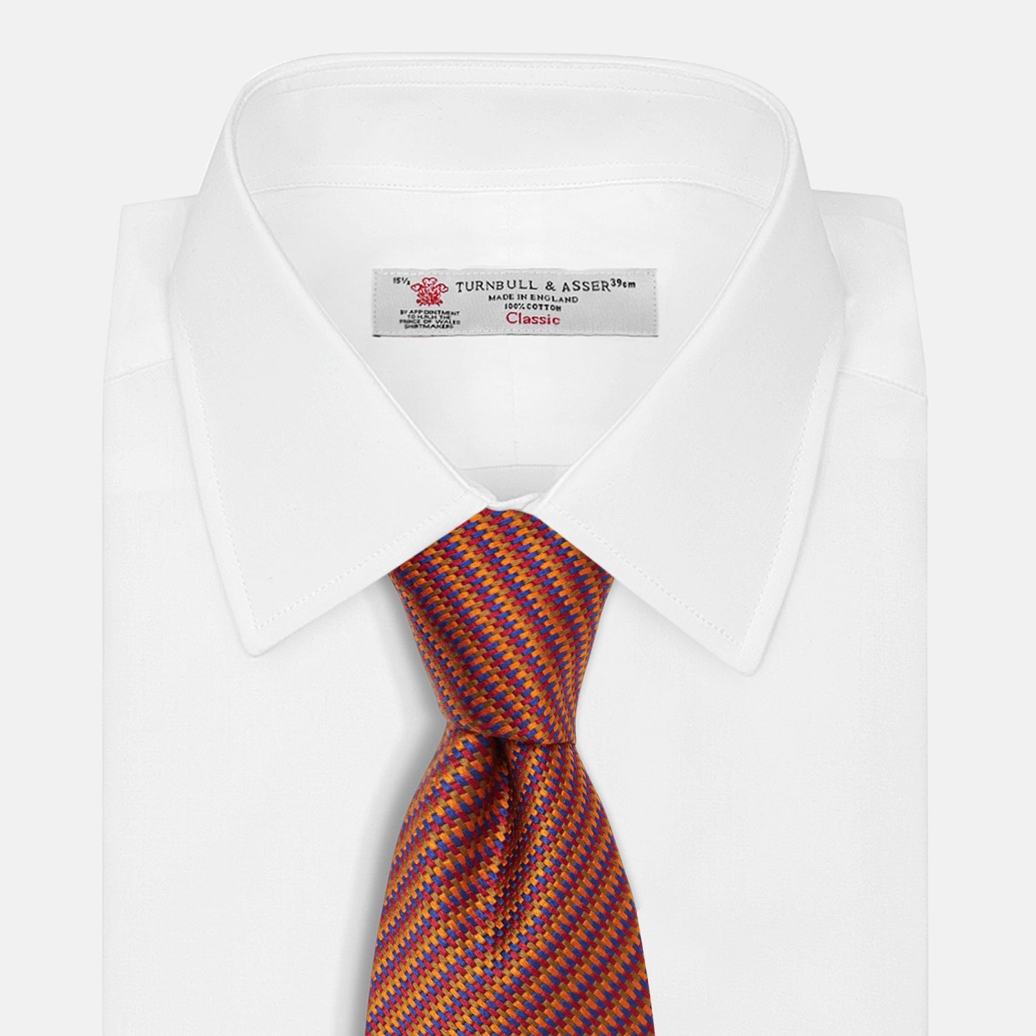 Image 2 of product The Turnbull & Asser Die Another Day Stripe Silk Tie, as seen on James Bond, showcases a vibrant orange, red, and purple woven pattern, elegantly rolled and displayed against a white background.