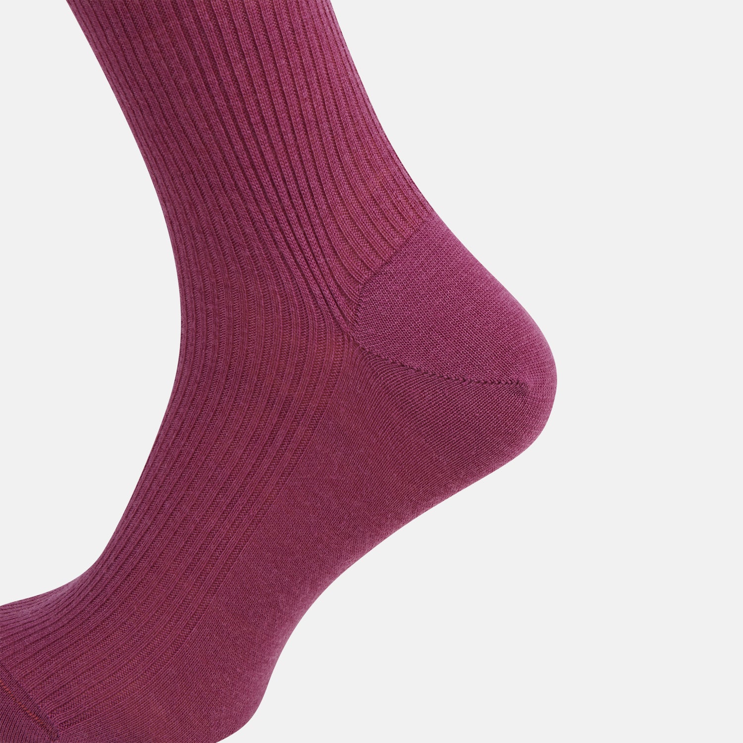 Image 4 of product A single Turnbull & Asser Mauve Mid-Length Merino Sock is shown upright, foot angled downward, against a plain light gray background. The ribbed sock features a solid mauve color.