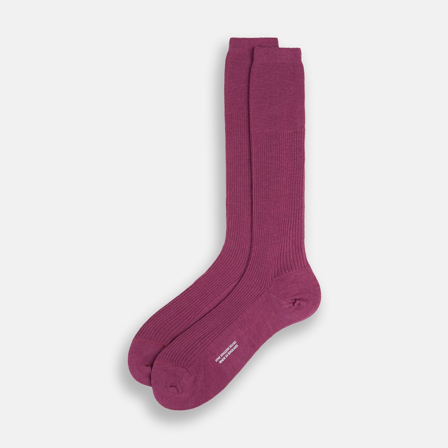 Image 2 of product A single Turnbull & Asser Mauve Mid-Length Merino Sock is shown upright, foot angled downward, against a plain light gray background. The ribbed sock features a solid mauve color.