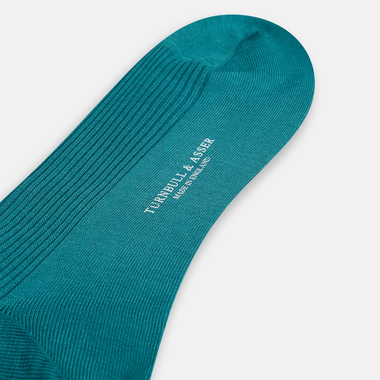 Image 3 of product A single Turnbull & Asser Teal Mid-Length Merino Sock stands upright against a white background, featuring a ribbed texture and the signature elegance of luxury merino wool.