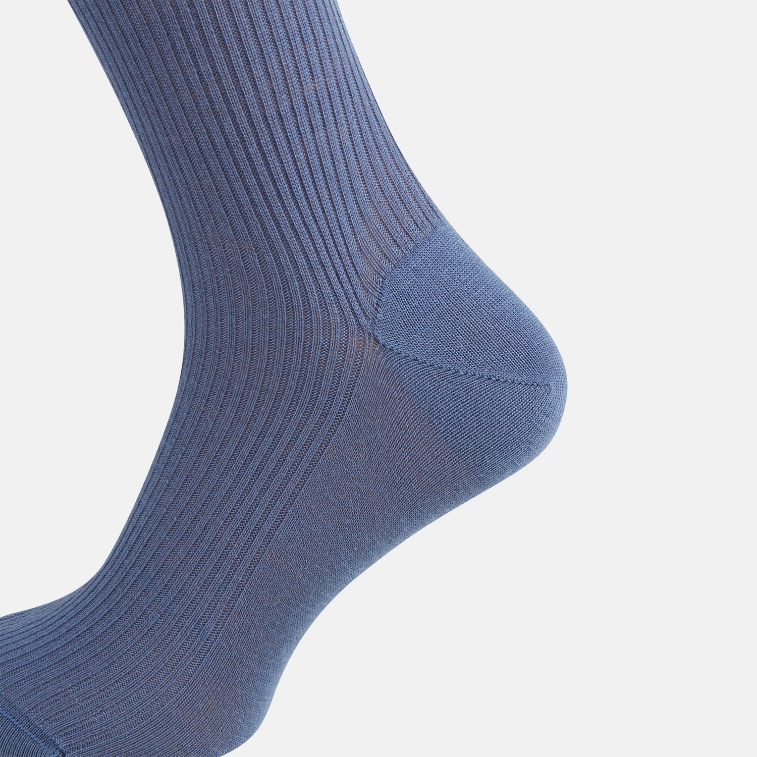 Image 4 of product A single Powder Blue Mid-Length Merino Sock by Turnbull & Asser stands upright against a white background, showcasing its smooth texture and subtle vertical lines, with a length that reaches just below the knee.
