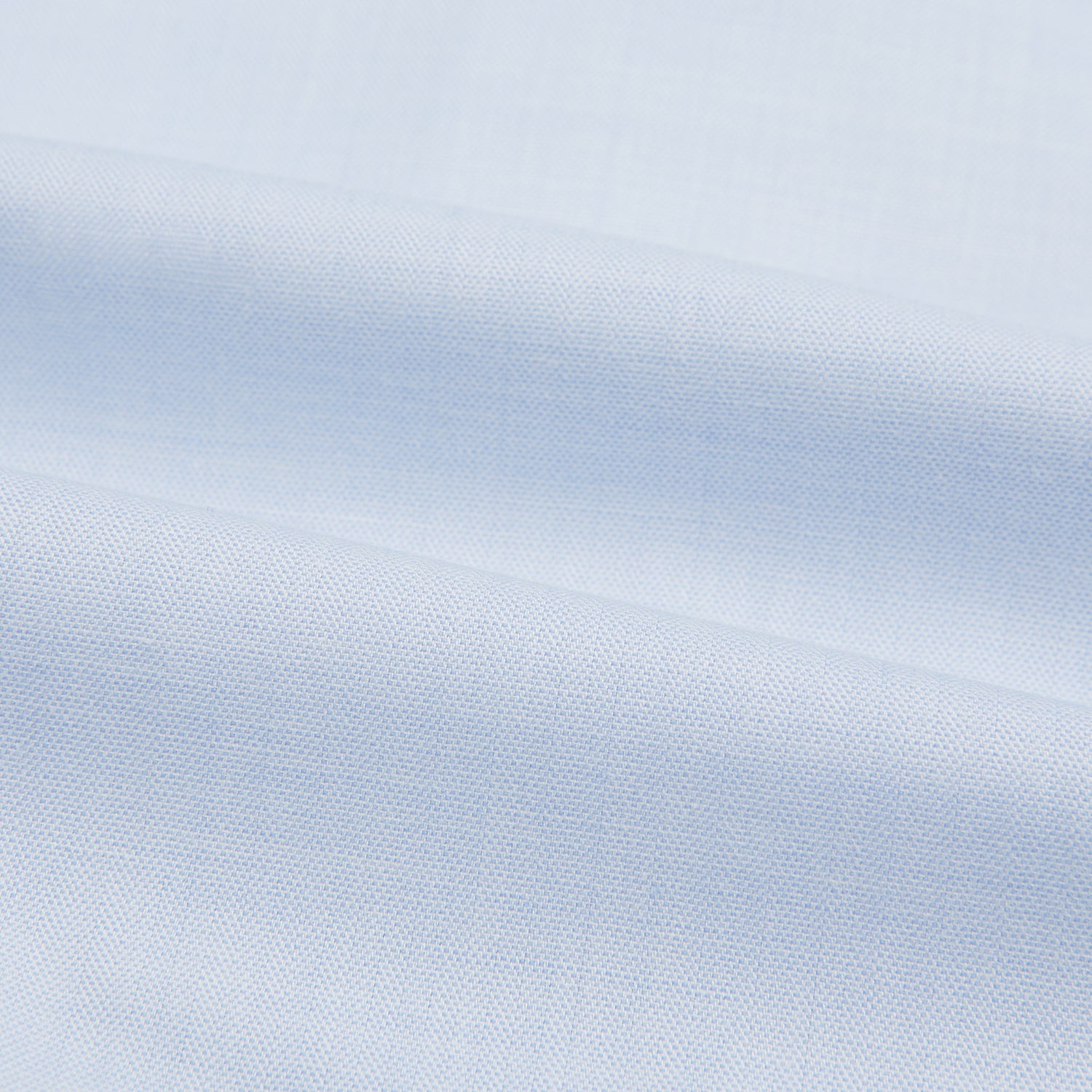 Image 5 of product The Turnbull & Asser Blue Cashmerello Mayfair Shirt is a light blue cotton-cashmere blend with long sleeves, pointed collar, white buttons, and buttoned cuffs, shown on a plain white background.