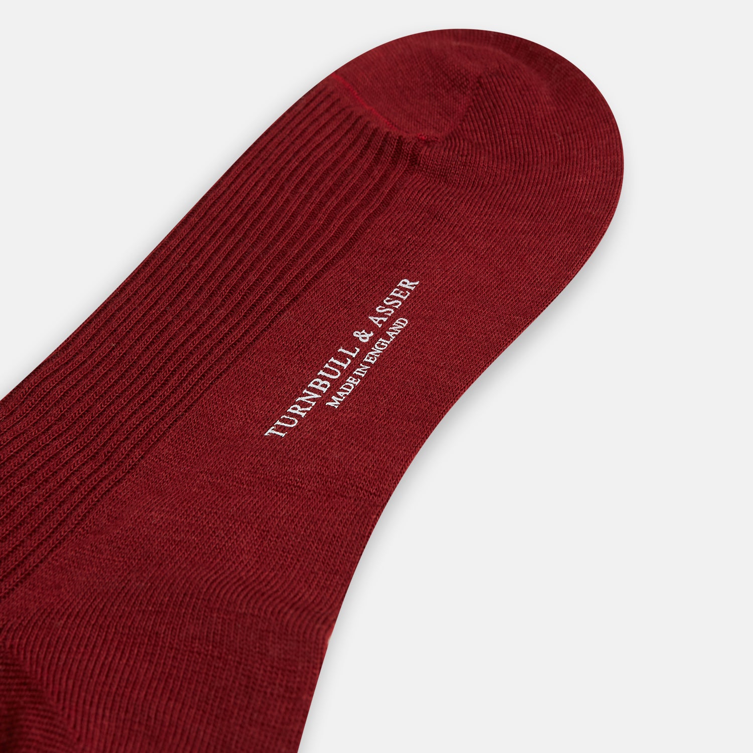 Image 3 of product A single Burgundy Mid-Length Merino Sock by Turnbull & Asser, ribbed and crafted from soft merino wool, is displayed upright against a plain white background.