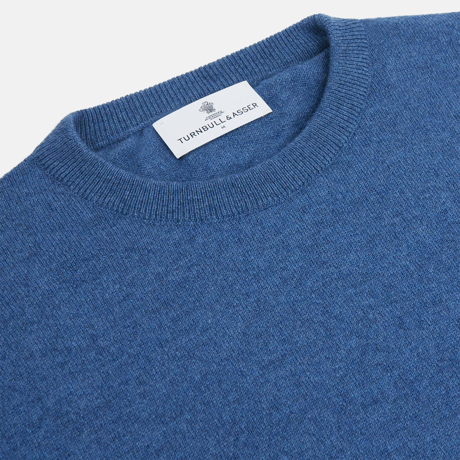 Image 2 of product The Turnbull & Asser Blue Crew Neck Cashmere Jumper is laid flat on a white background, showcasing ribbed cuffs, hem, and neckline for an elegant, smart-casual style.
