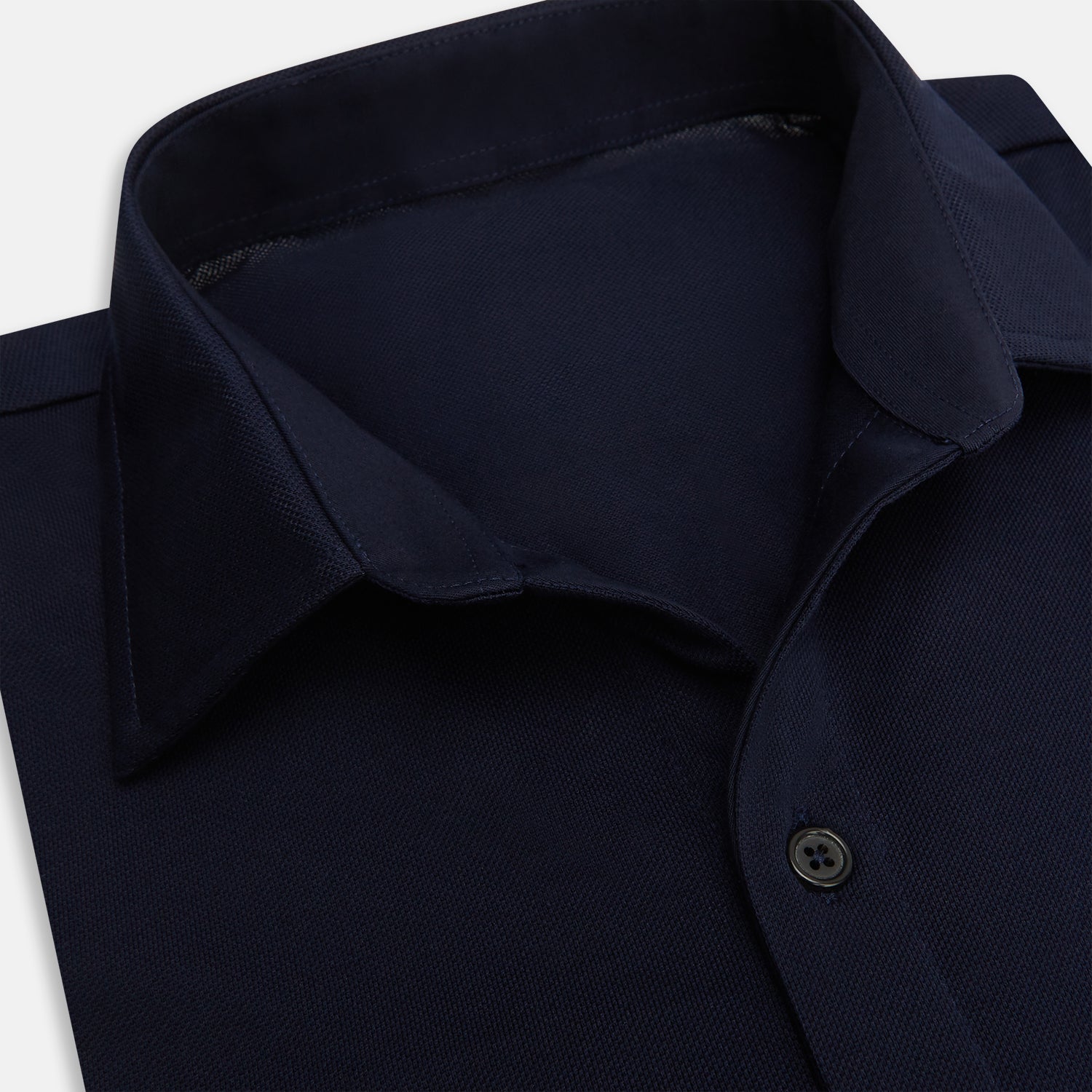 Image 2 of product The Turnbull & Asser Navy Pique Shirt is a long-sleeved, dark navy button-up with a left chest pocket, classic collar, and buttoned cuffs, shown laid flat on a white background.