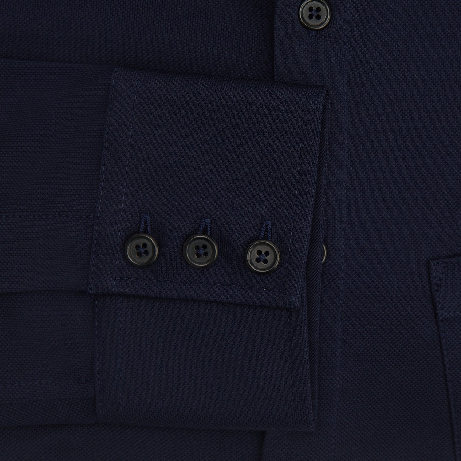 Image 4 of product The Turnbull & Asser Navy Pique Shirt is a long-sleeved, dark navy button-up with a left chest pocket, classic collar, and buttoned cuffs, shown laid flat on a white background.