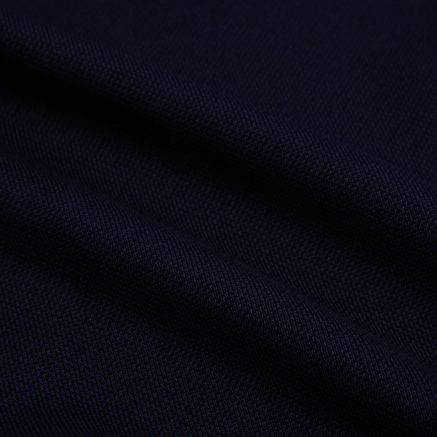 Image 6 of product The Turnbull & Asser Navy Pique Shirt is a long-sleeved, dark navy button-up with a left chest pocket, classic collar, and buttoned cuffs, shown laid flat on a white background.