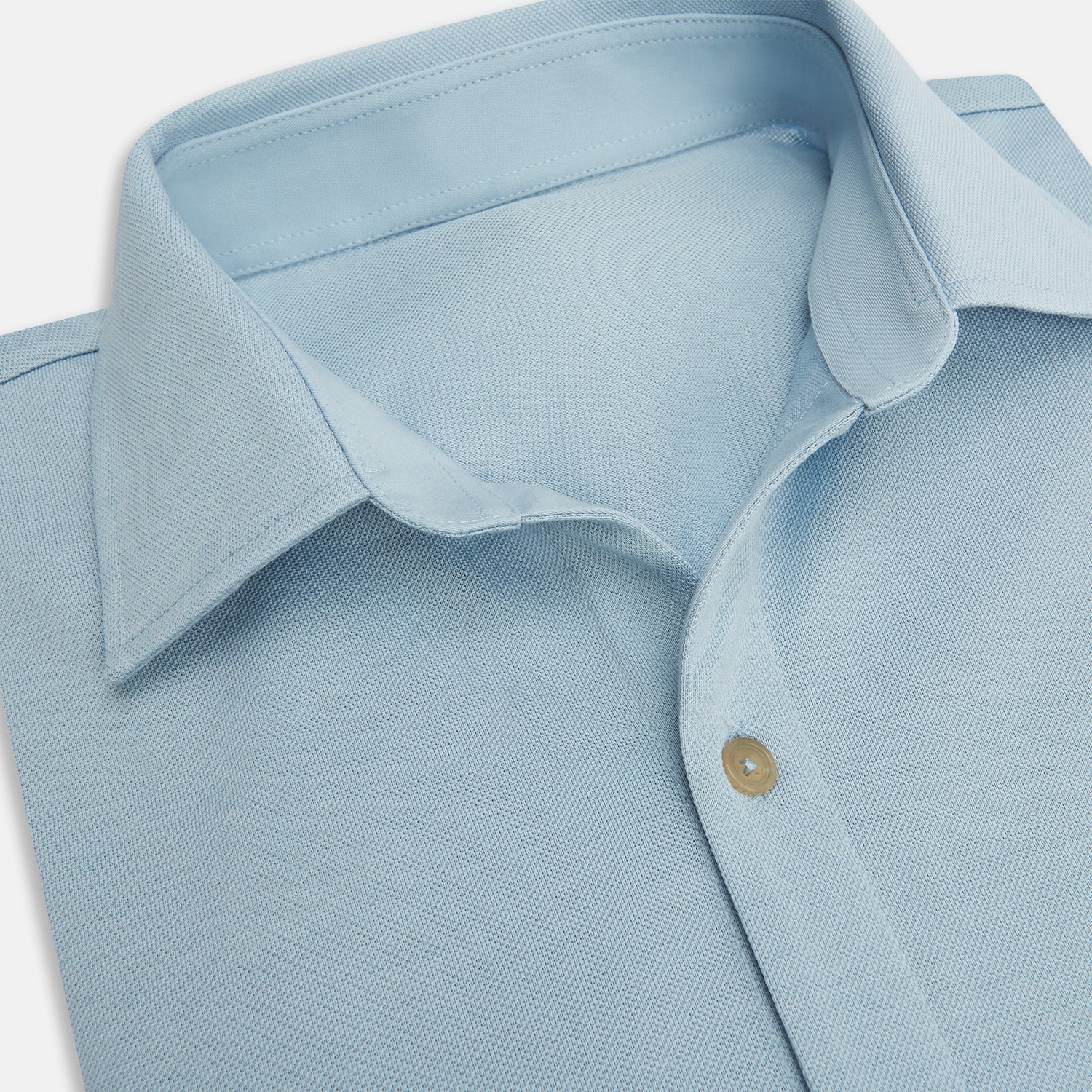 Image 2 of product The Turnbull & Asser Pale Blue Pique Shirt is a long-sleeve button-up with an open collar, single chest pocket, and beige buttons, shown against a white background.