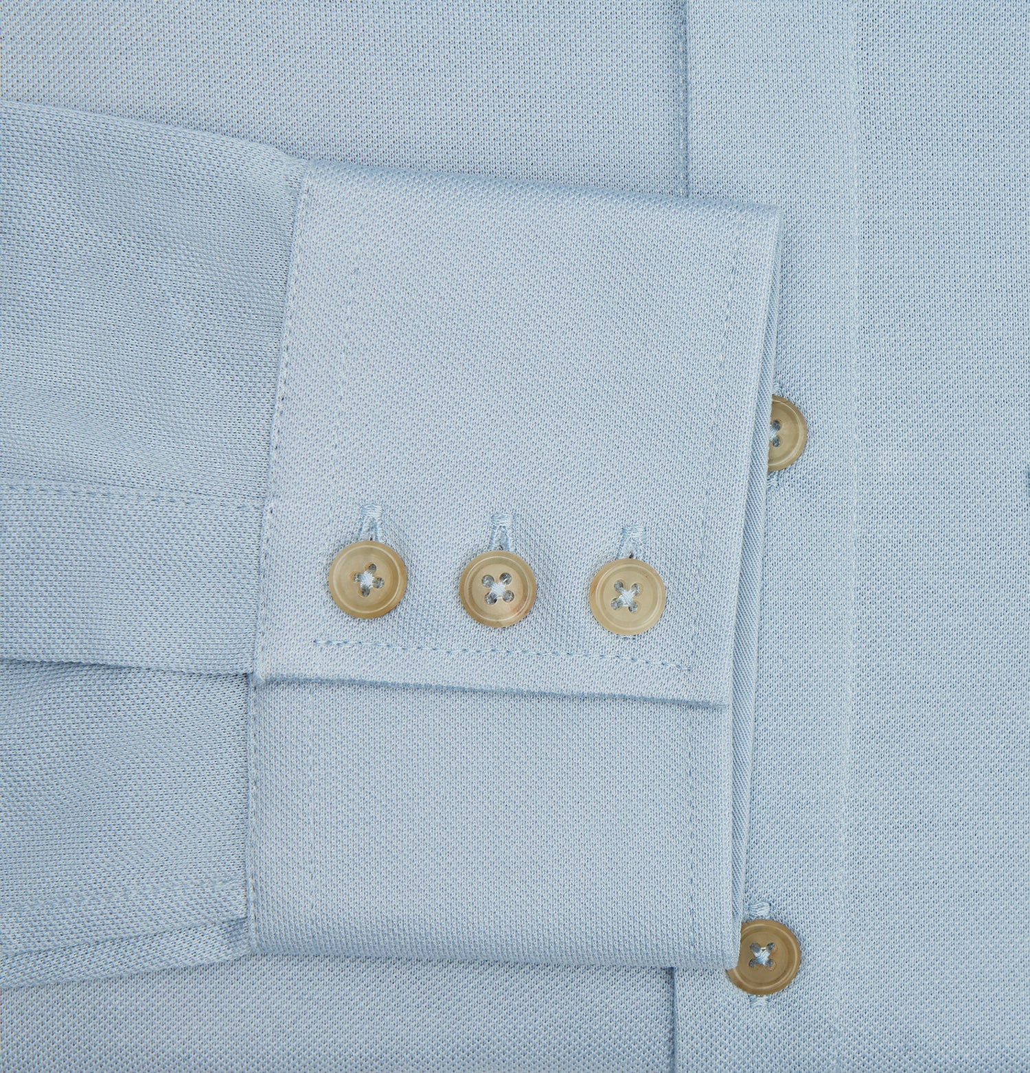 Image 4 of product The Turnbull & Asser Pale Blue Pique Shirt is a long-sleeve button-up with an open collar, single chest pocket, and beige buttons, shown against a white background.
