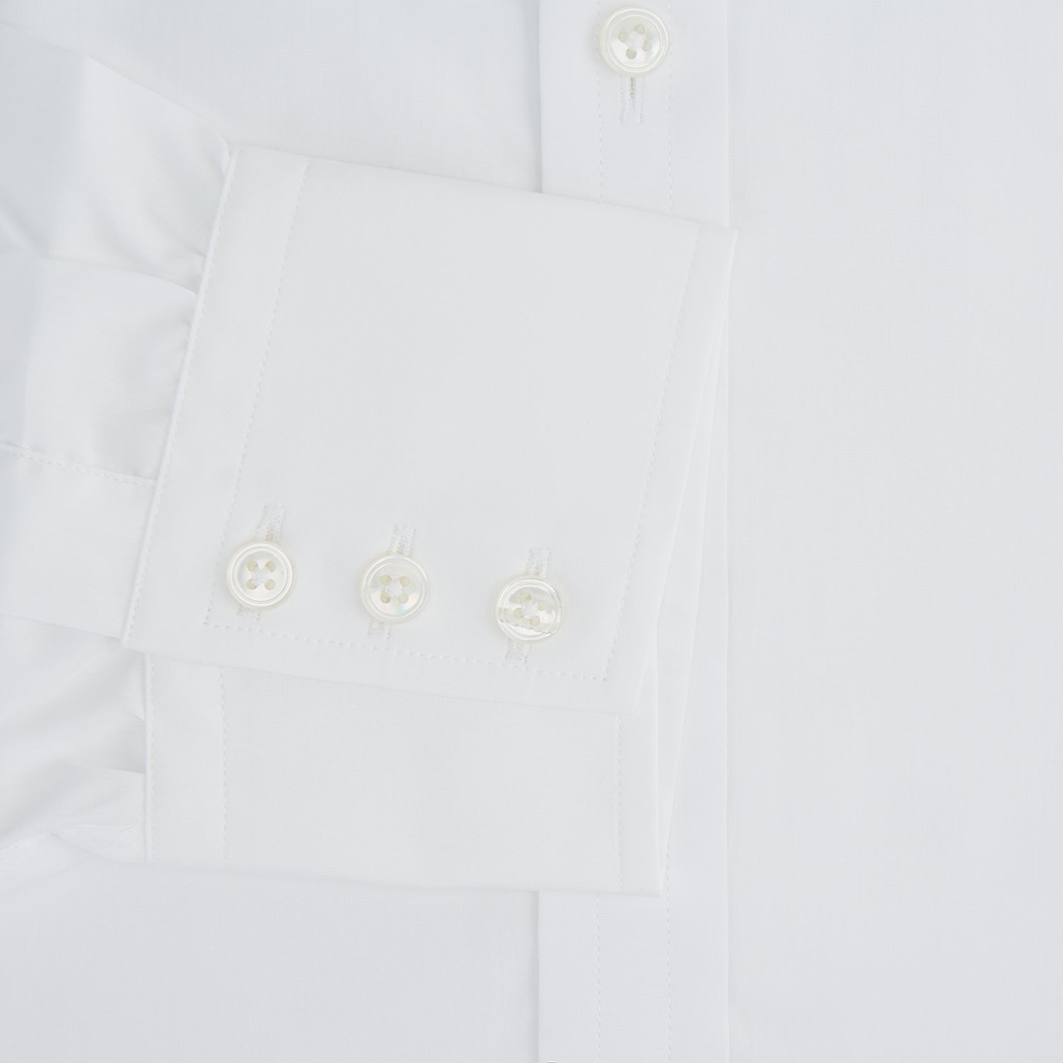 Image 4 of product The Turnbull & Asser Plain White Cotton Shirt features a stylish T&A collar and 3-button cuffs, ideal for minimalist outfits or statement ties, shown against a simple white background.