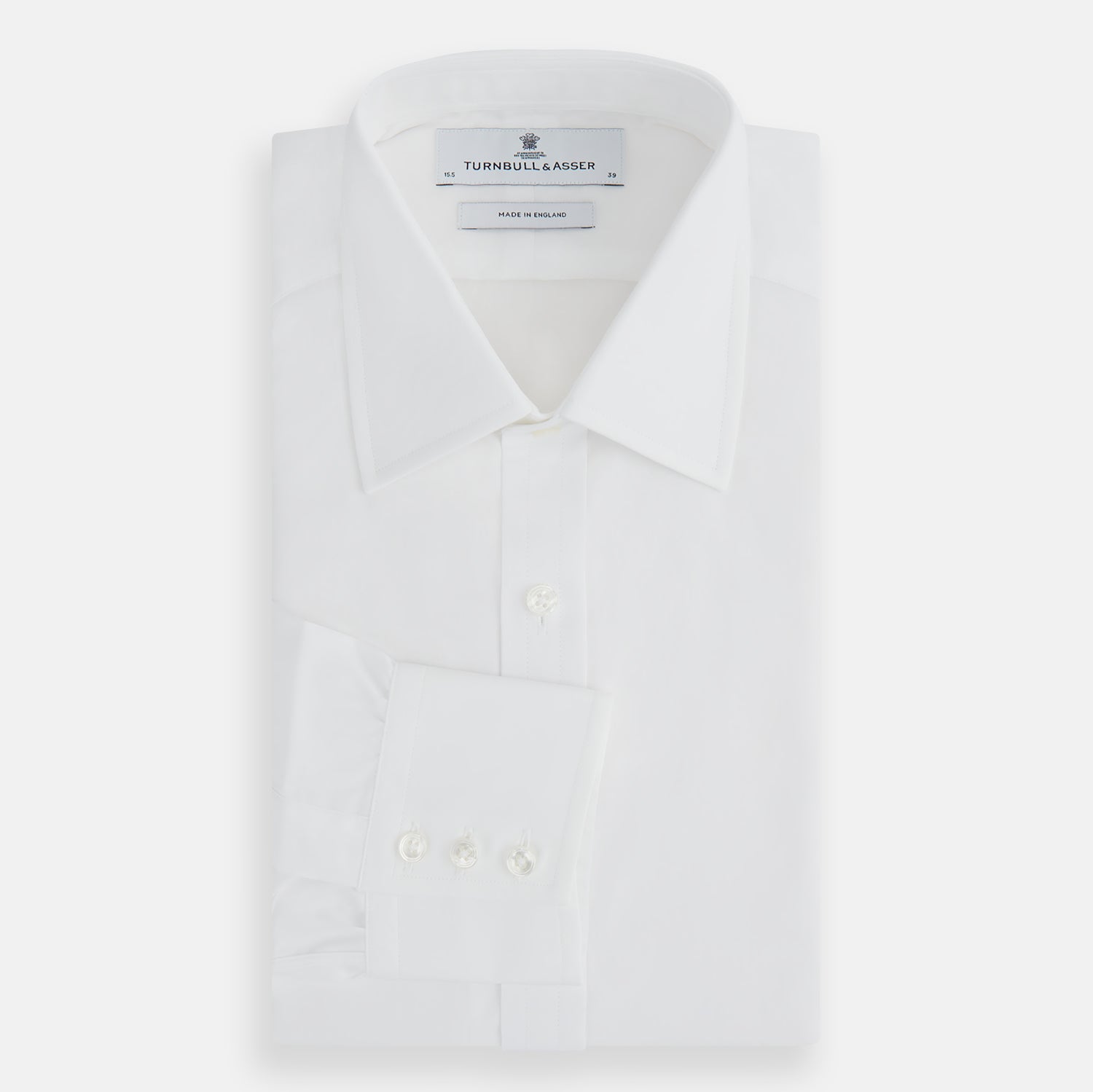 Image 5 of product The Turnbull & Asser Plain White Cotton Shirt features a stylish T&A collar and 3-button cuffs, ideal for minimalist outfits or statement ties, shown against a simple white background.