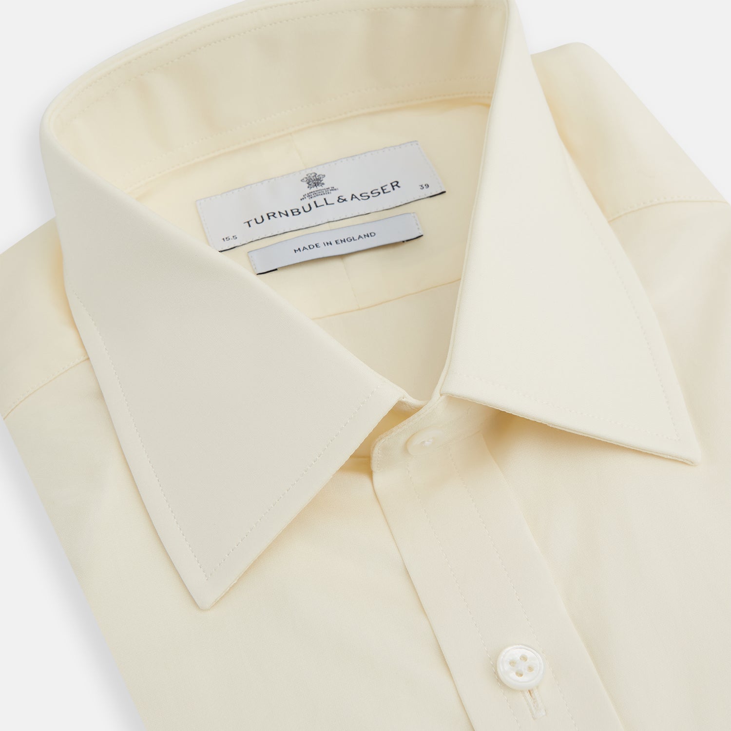 Image 2 of product The Turnbull & Asser Cream Cotton Shirt features a T&A collar, button-up front, and 3-button cuffs, displayed on a plain white background.