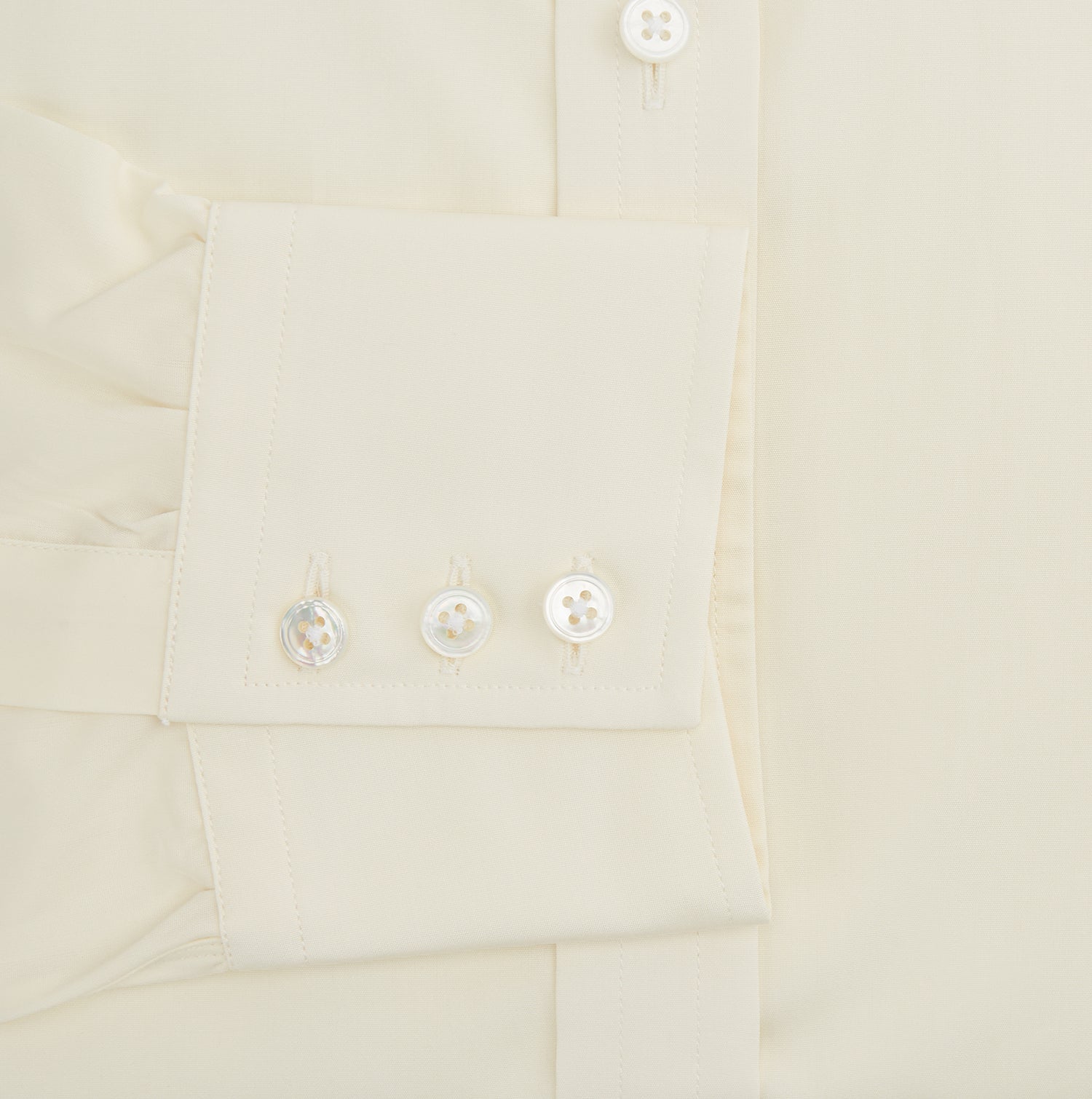 Image 4 of product The Turnbull & Asser Cream Cotton Shirt features a T&A collar, button-up front, and 3-button cuffs, displayed on a plain white background.