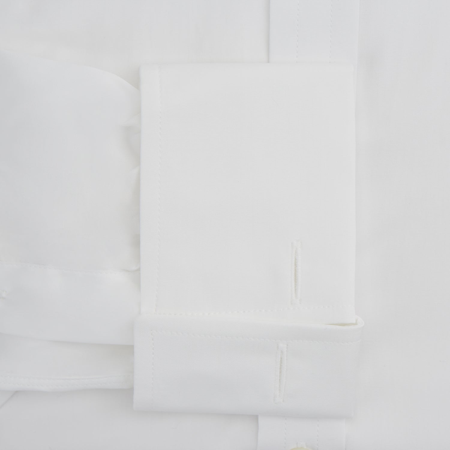 Image 4 of product The Turnbull & Asser White Sea Island Quality Cotton Shirt features a T&A collar and double cuffs, crafted from premium cotton and shown laid flat against a white background.