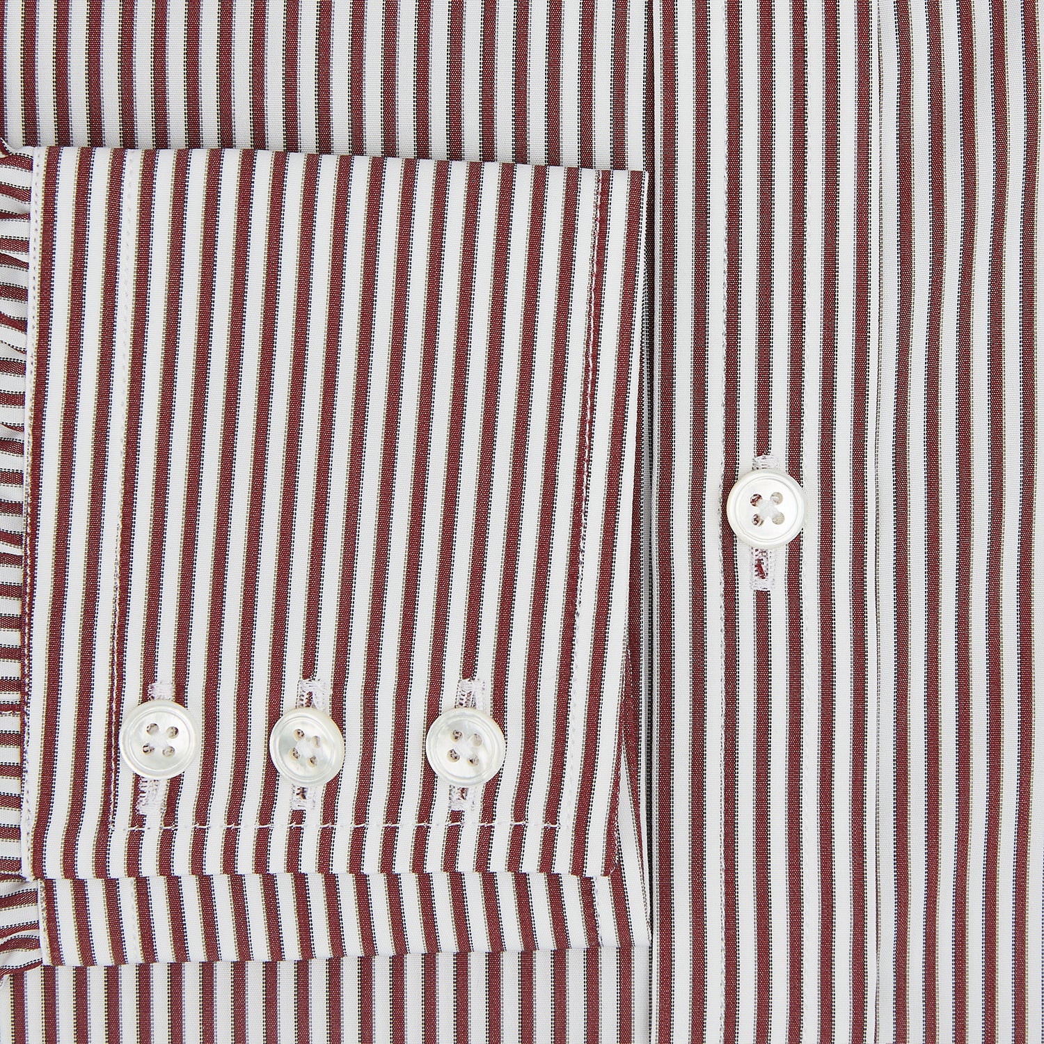 Image 4 of product The Turnbull & Asser Burgundy Halo Stripe Winston Shirt features long sleeves, a classic T&A collar, buttoned cuffs, narrow vertical burgundy and white stripes, and is crafted from organic cotton. Displayed on a white background.