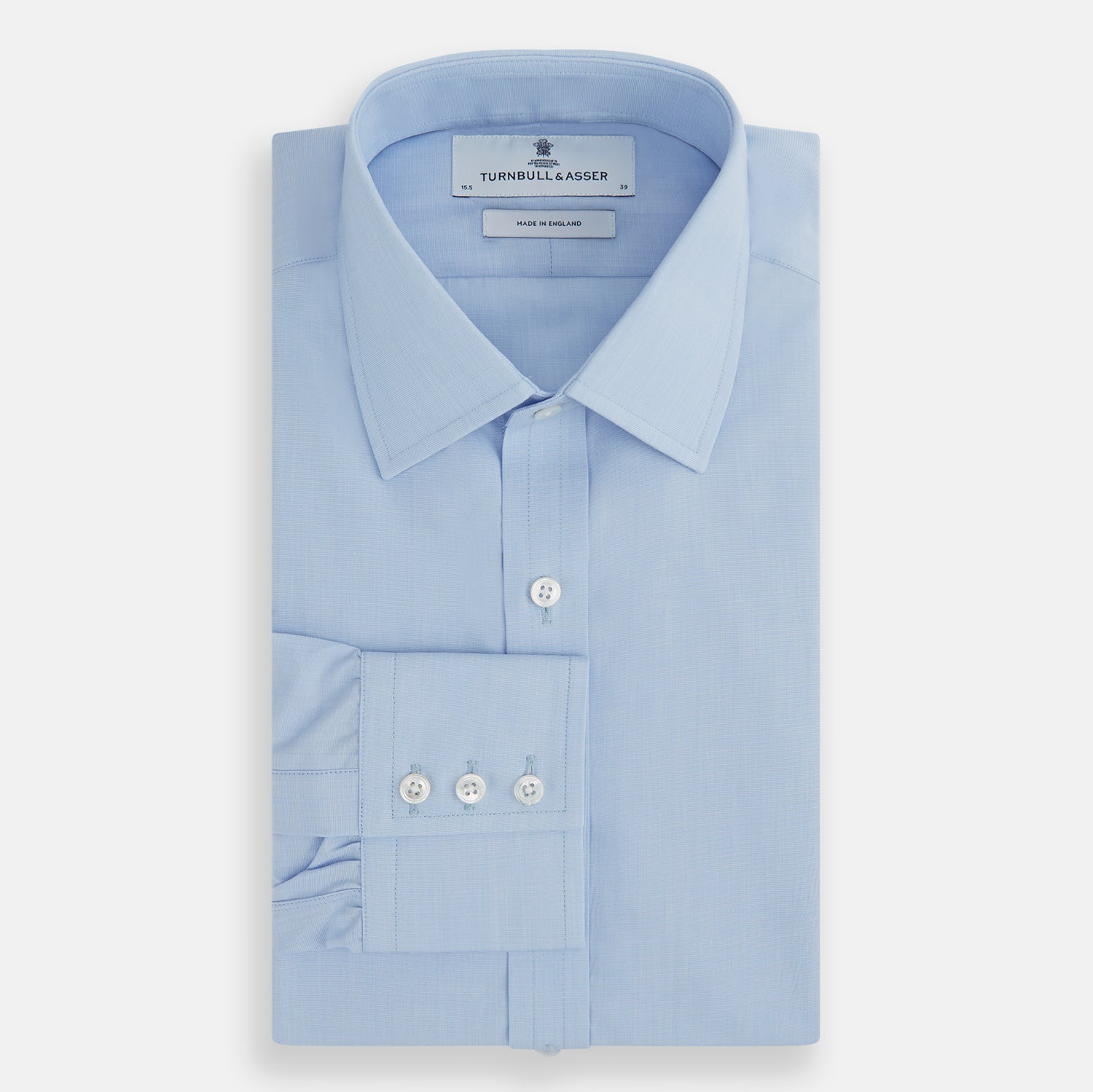 Image 4 of product The Turnbull & Asser Light Blue End-on-End Shirt, featuring a T&A collar and 3-button cuffs, is laid flat on a white background—perfect for smart looks or complementing your favorite navy suit.