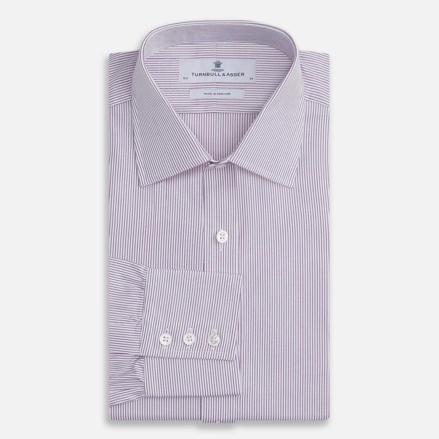 Image 4 of product The Purple Pinstripe Mayfair Shirt by Turnbull & Asser is a light purple cotton poplin long-sleeve button-up with white stripes, a pointed collar, white buttons, and cuffed sleeves, shown laid flat on a white background.