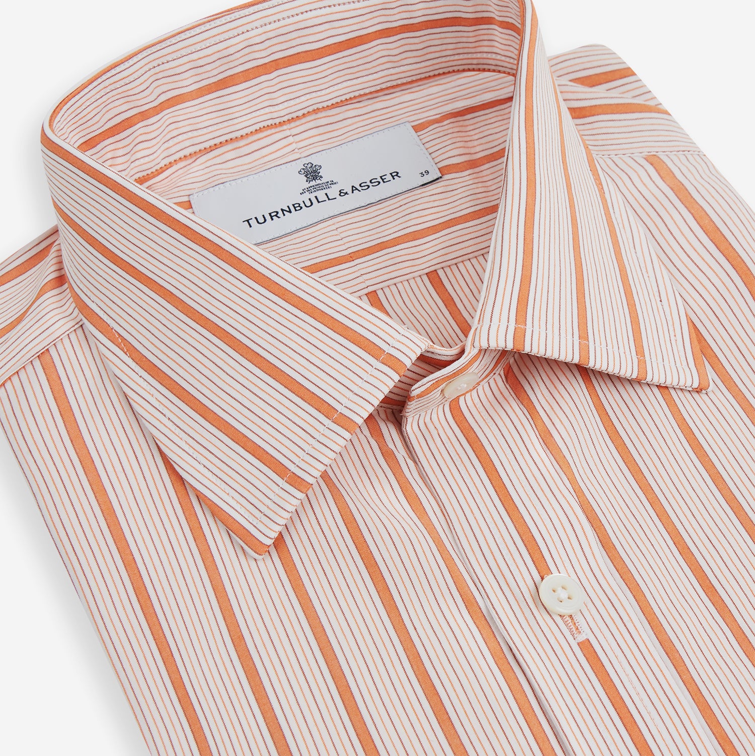 Image 2 of product The Orange Graph Overlay Check Mayfair Shirt by Turnbull & Asser is a long-sleeved organic cotton button-up with orange and white stripes, a collar, and wide cuffs—ideal for elevating your wardrobe. Shown against a white background.