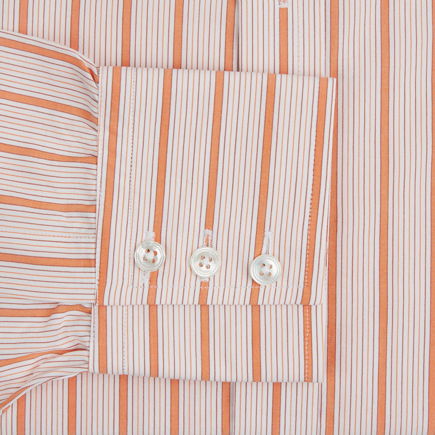 Image 3 of product The Orange Graph Overlay Check Mayfair Shirt by Turnbull & Asser is a long-sleeved organic cotton button-up with orange and white stripes, a collar, and wide cuffs—ideal for elevating your wardrobe. Shown against a white background.