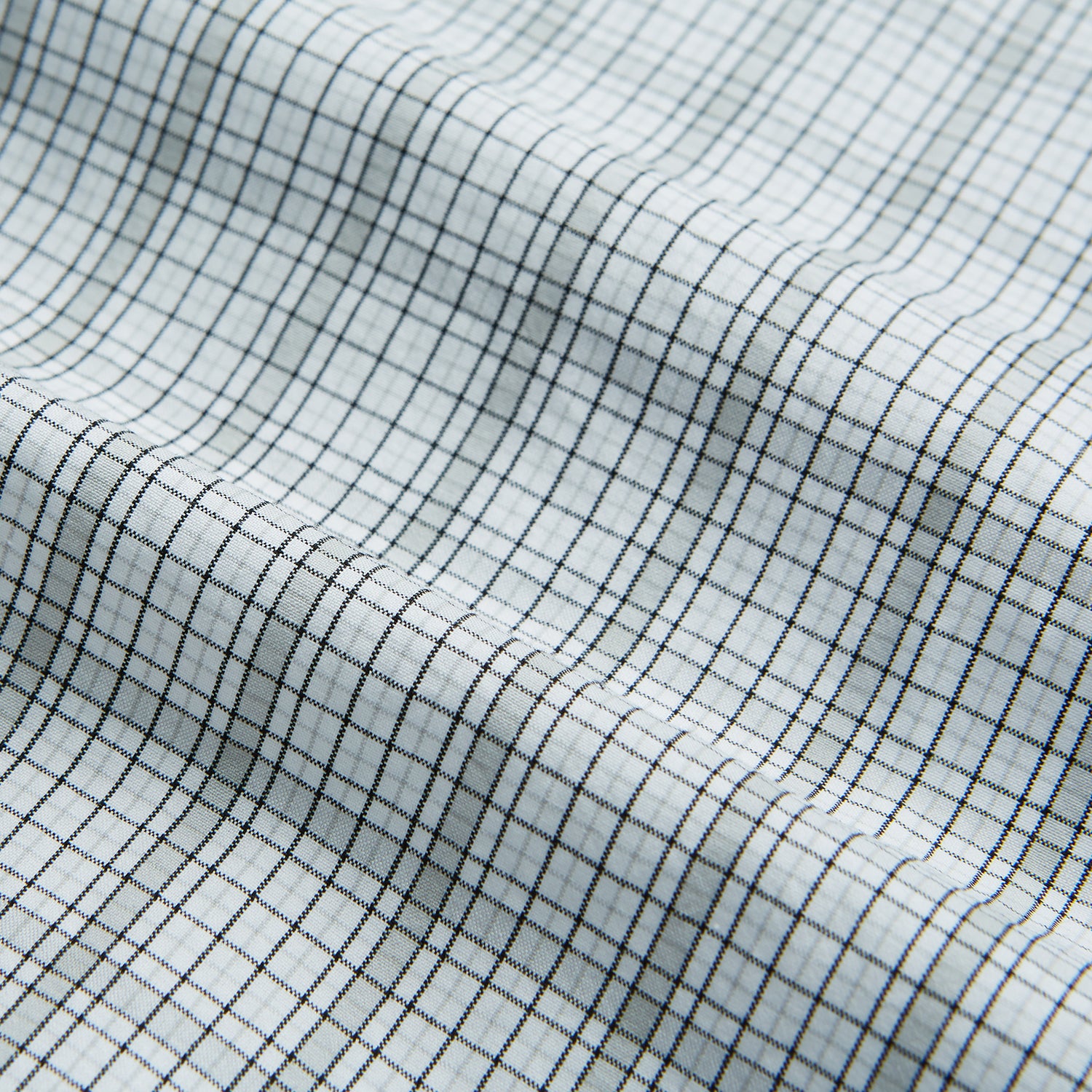 Image 5 of product The Turnbull & Asser Grey Fine Multi Graph Check Mayfair Shirt features a breathable cotton fabric, classic T&A collar, white buttons, and a subtle plaid pattern, displayed on a white background.
