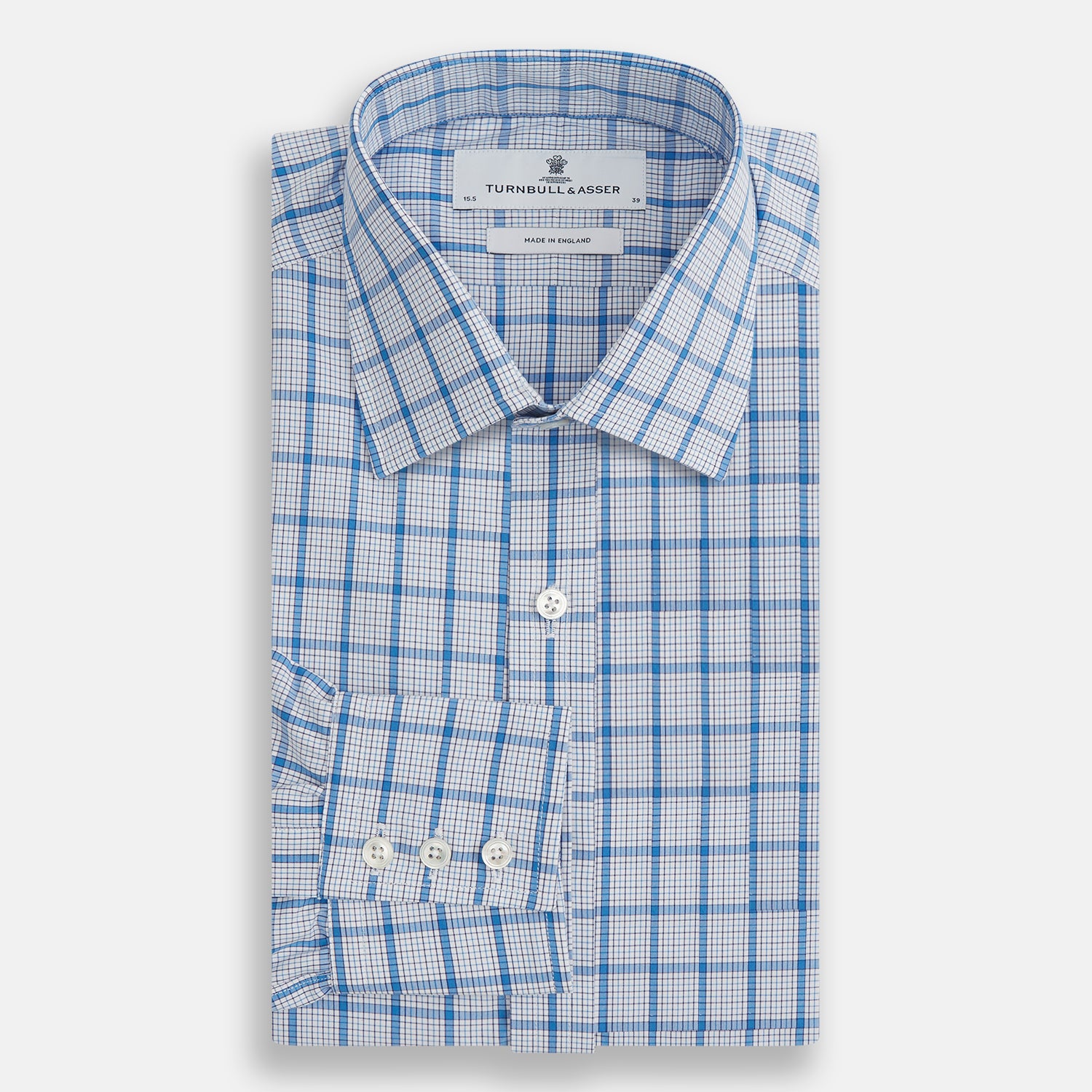 Image 4 of product The Turnbull & Asser Blue Graph Overlay Check Mayfair Shirt features long sleeves, a spread collar, buttoned cuffs, and a blue and white plaid pattern, shown against a plain white background.