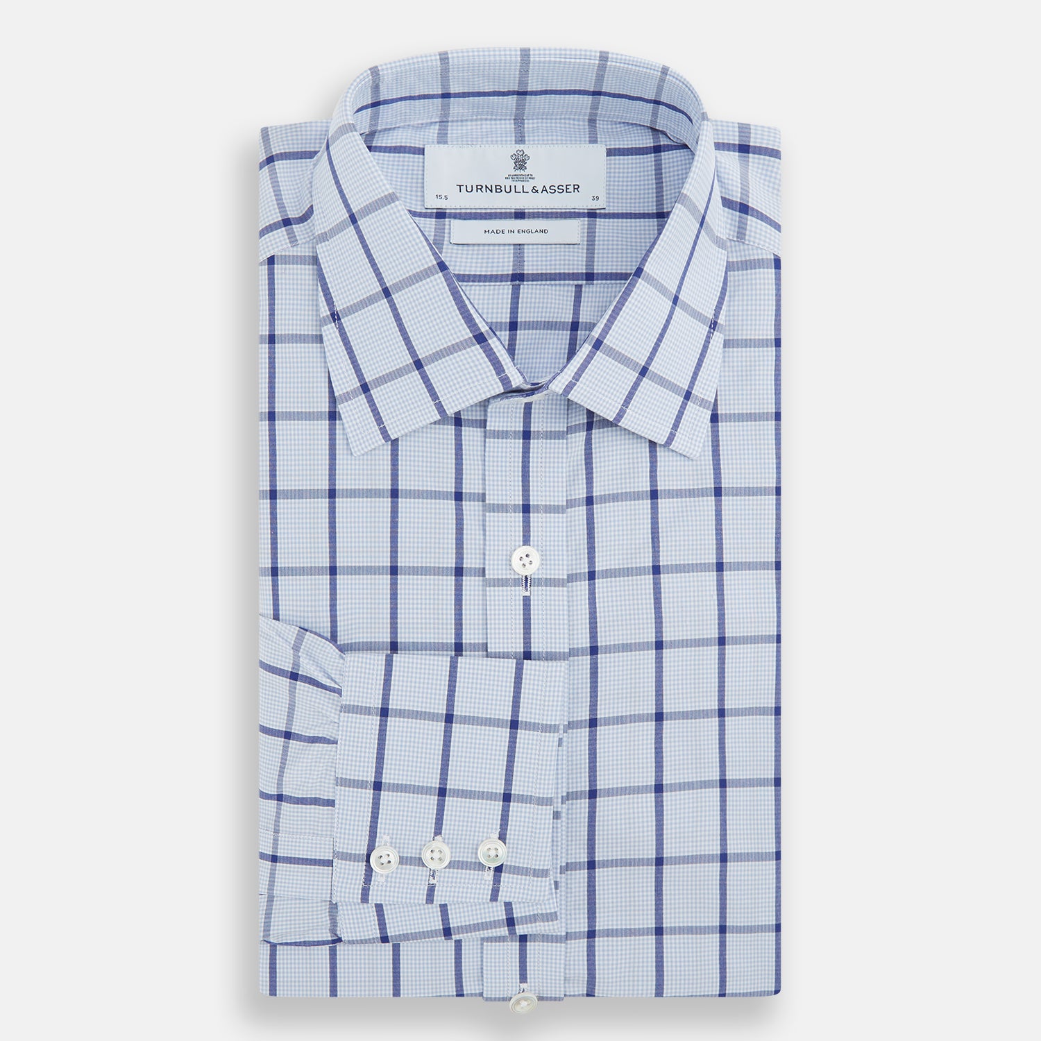 Image 4 of product The Turnbull & Asser Navy Blue Windowpane Check Mayfair Shirt is a long-sleeved, organic cotton, button-up dress shirt with a classic collar and buttoned cuffs—white fabric with navy windowpane checks, ideal for any wardrobe capsule.