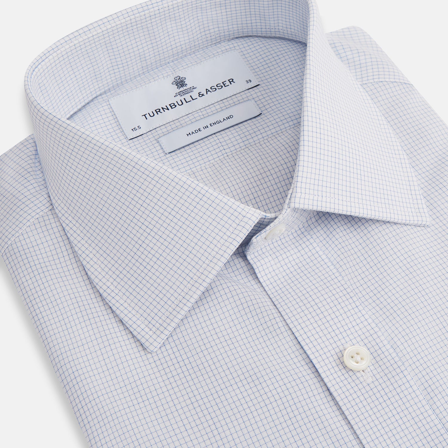 Image 2 of product The Turnbull & Asser Blue Fine Graph Check Mayfair Shirt, made from breathable cotton, features long sleeves, a T&A collar, white buttons, and buttoned cuffs, displayed flat on a white background.
