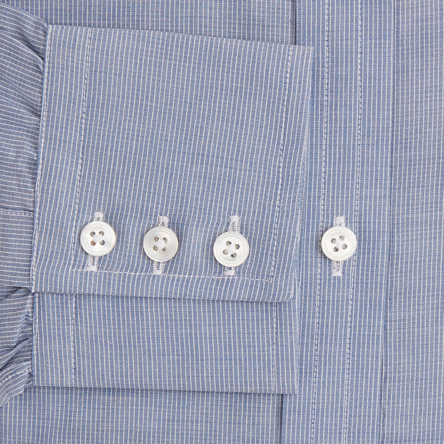 Image 3 of product The Turnbull & Asser Blue Pencil Stripe Mayfair Shirt is crafted from organic cotton with a classic collar, white buttons, and buttoned cuffs. Shown laid flat on a white background.
