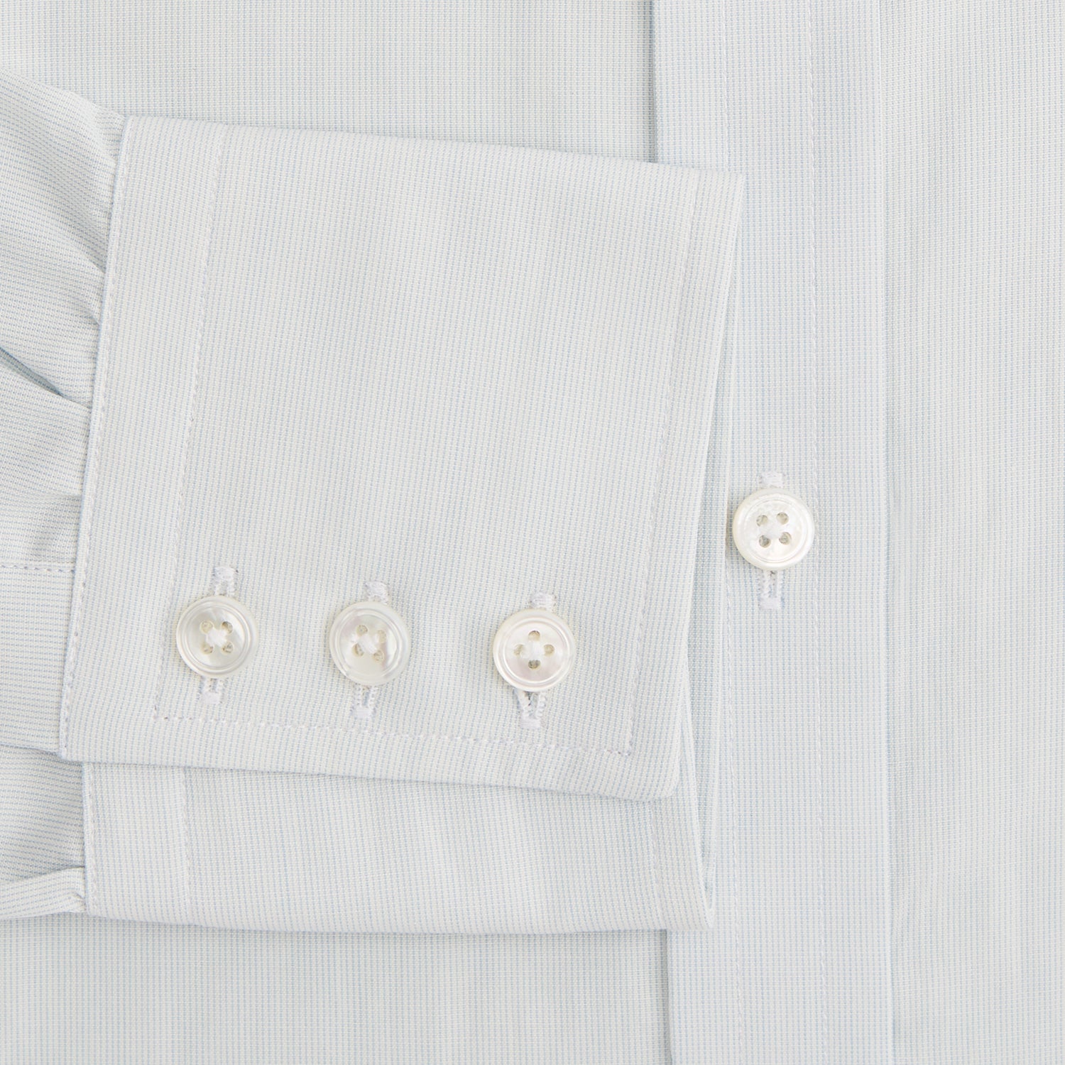 Image 4 of product Pale Blue Pencil Stripe Mayfair Shirt by Turnbull & Asser featuring a classic collar, white buttons, and cuffed long sleeves, displayed flat on a white background.