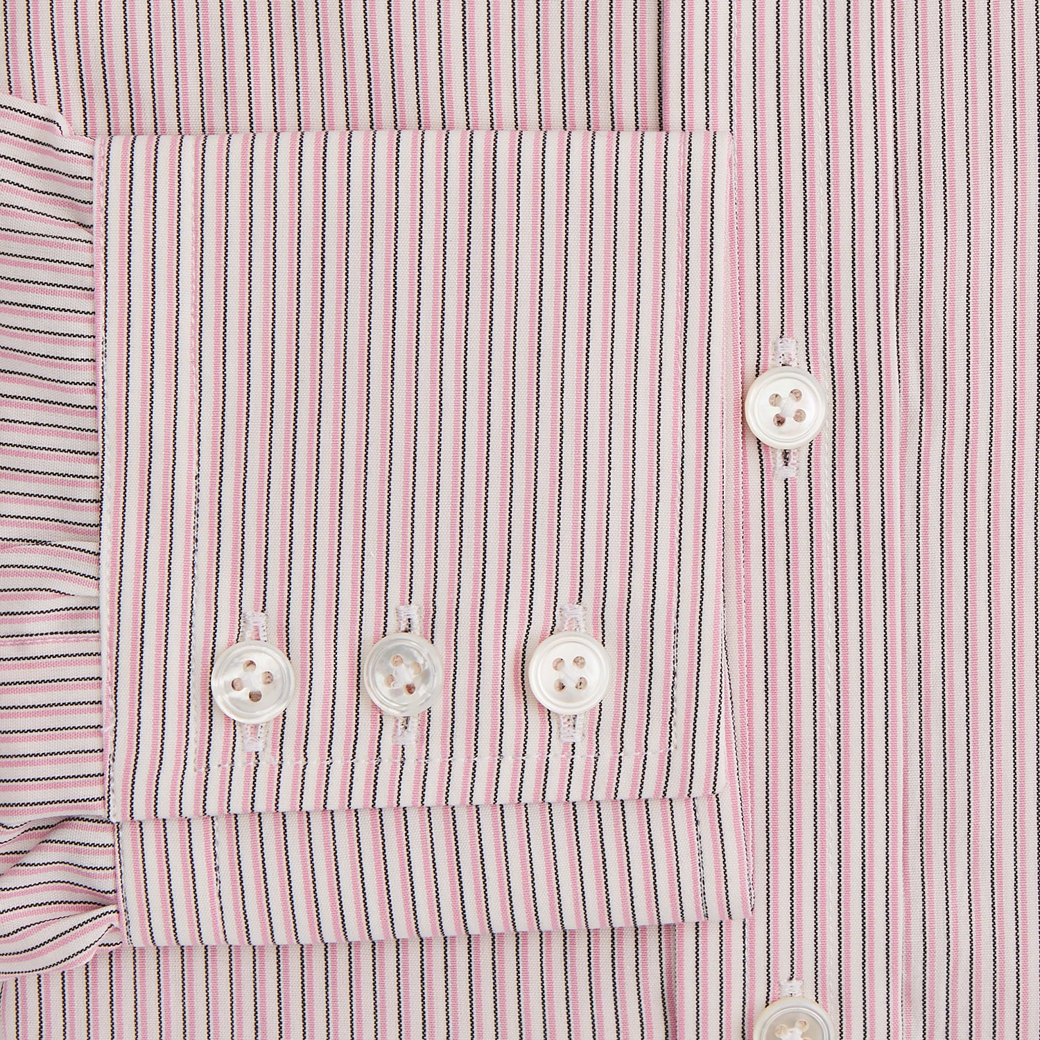 Image 3 of product The Turnbull & Asser Pink Fine Shadow Stripe Mayfair Shirt is a long-sleeved button-up with a classic T&A collar, crafted from pure cotton and featuring thin pink and white vertical stripes, shown on a plain white background.