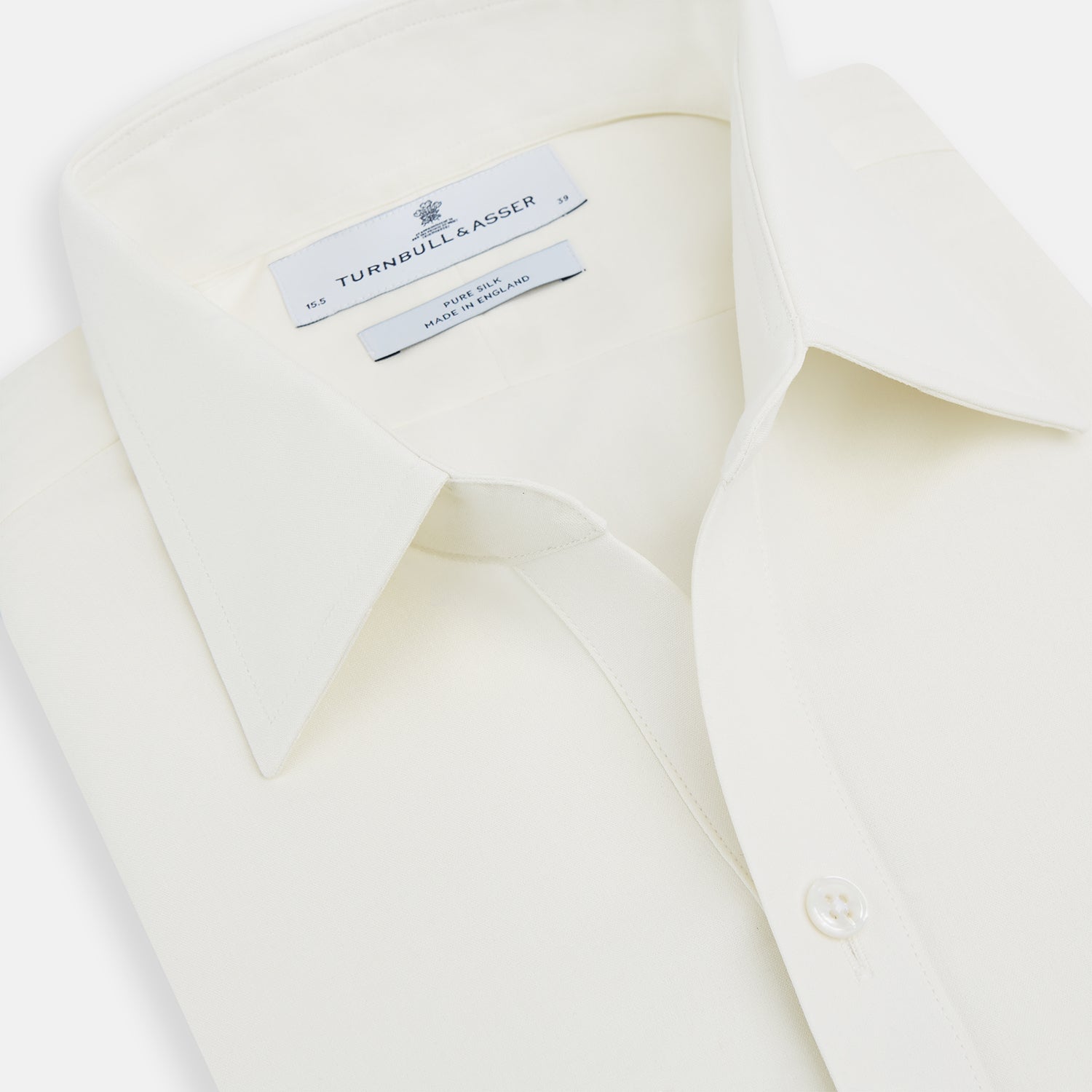 Image 2 of product The Turnbull & Asser Cream Silk Chelsea Shirt is an elegant white long-sleeve, button-up silk shirt with a single chest pocket, shown against a plain white background.