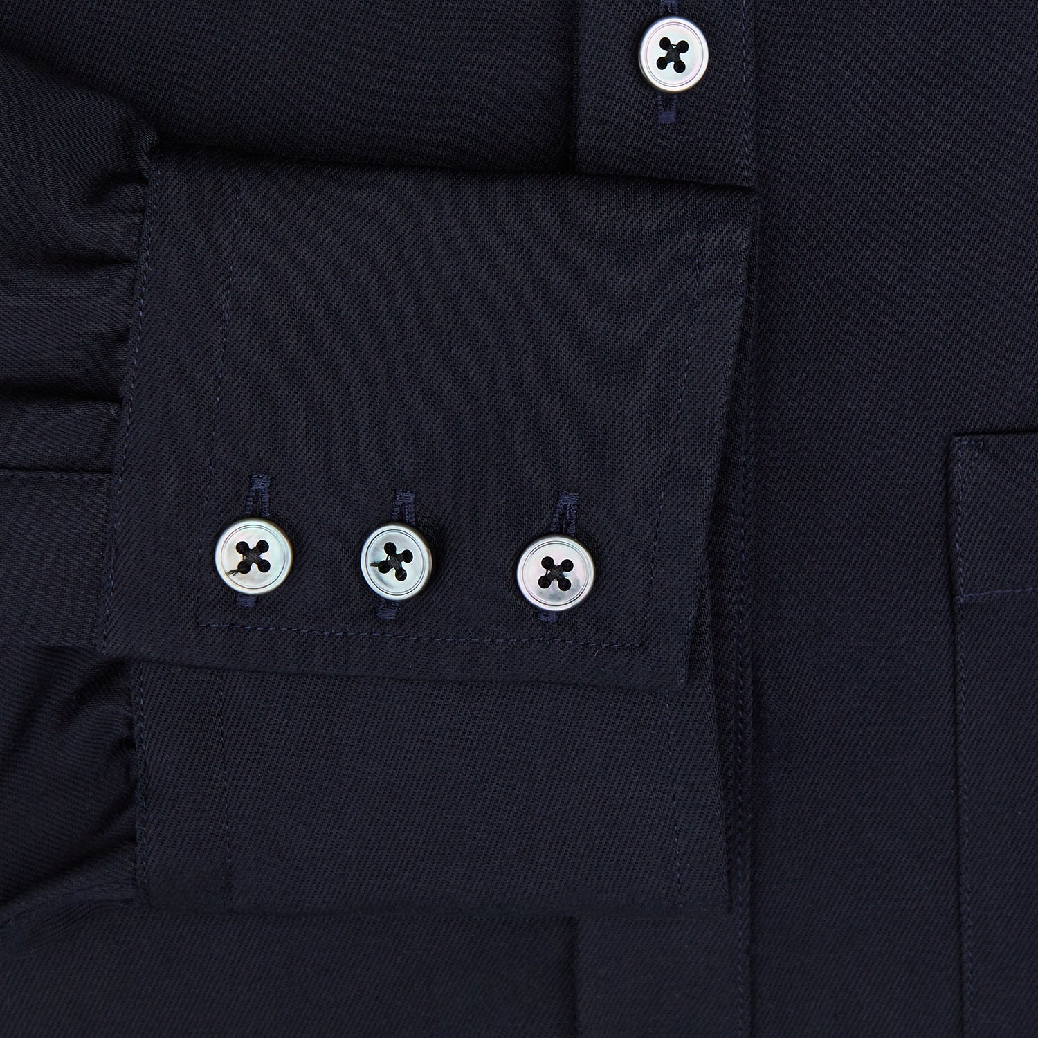 Image 4 of product The Turnbull & Asser Navy Twill Chelsea Shirt is a long-sleeve button-up with a collar, front chest pocket, and white buttons, shown against a plain white background.