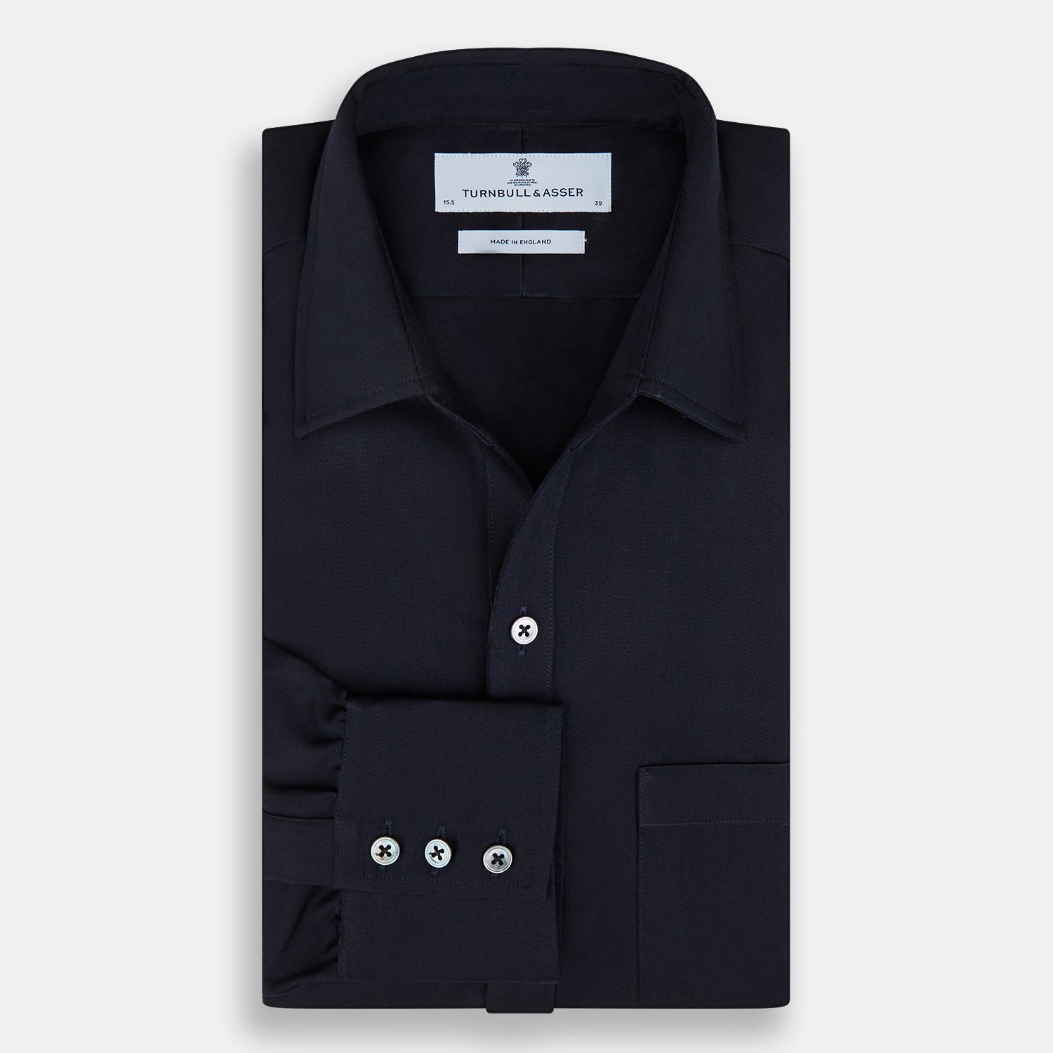 Image 5 of product The Turnbull & Asser Navy Twill Chelsea Shirt is a long-sleeve button-up with a collar, front chest pocket, and white buttons, shown against a plain white background.