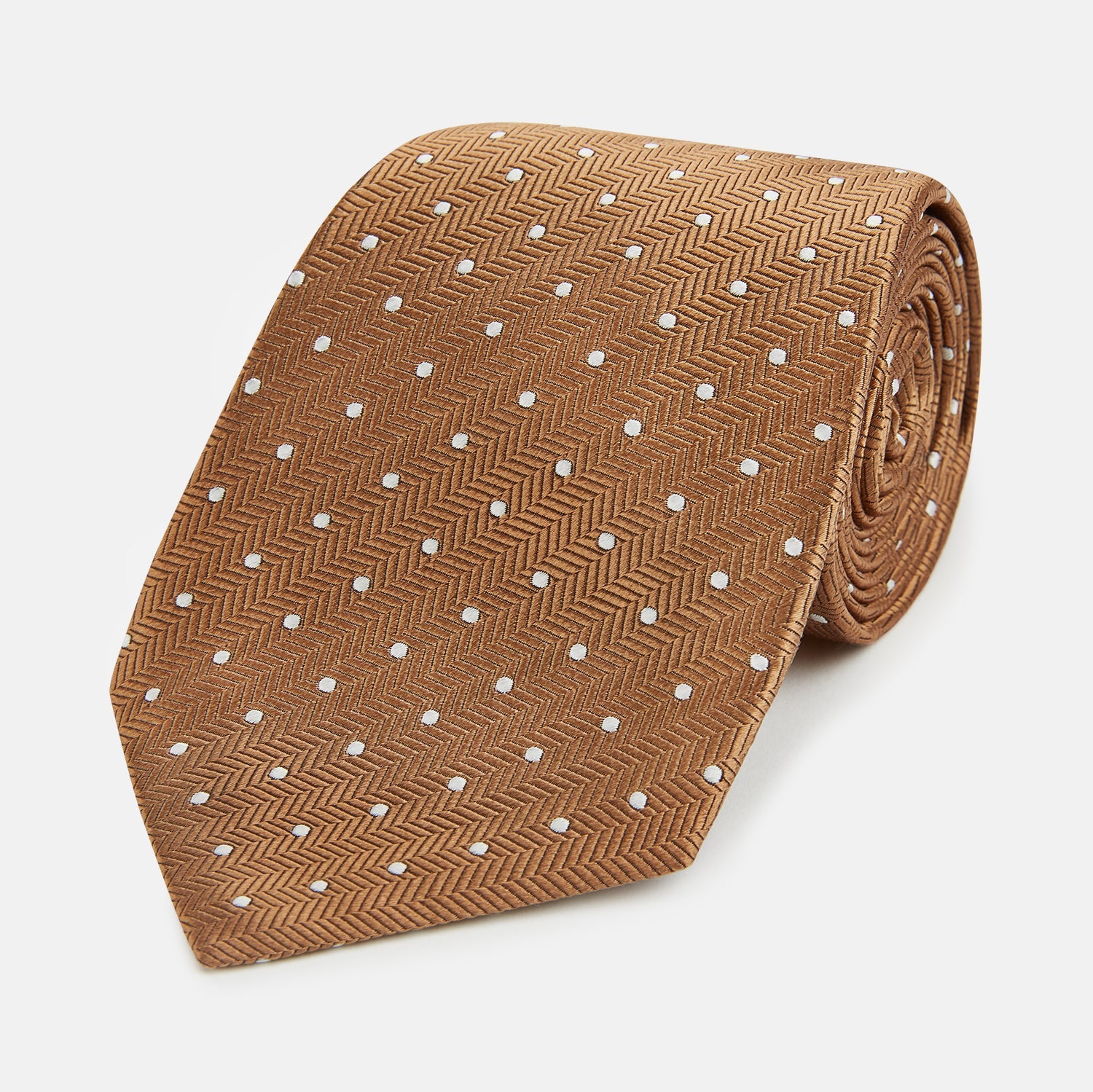 Image 1 of product The Turnbull & Asser Camel and White Small Spot Herringbone Silk Tie features a stylish herringbone pattern with white spots—an elegant accessory ideal for modern office attire.