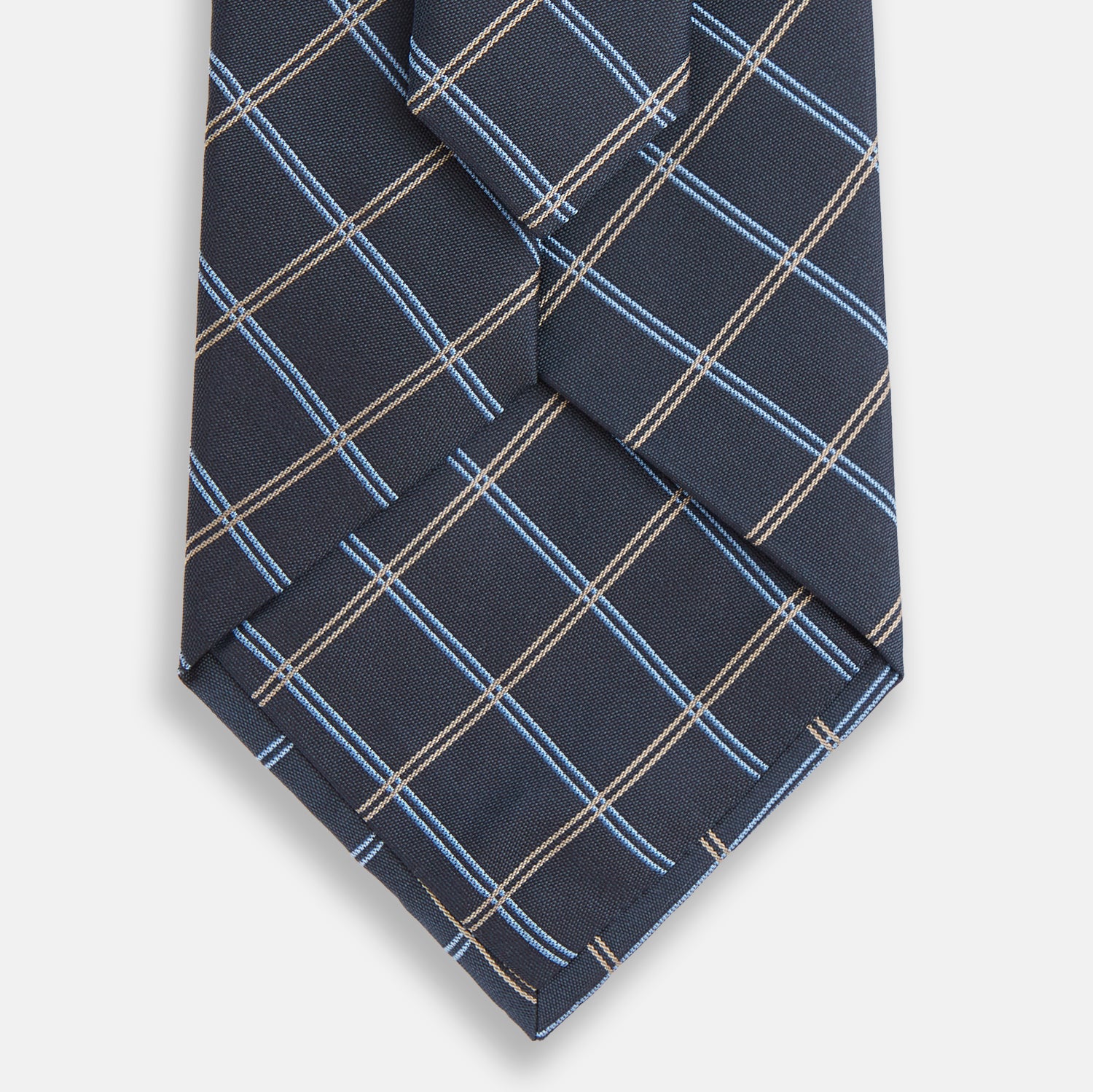 Image 3 of product The Turnbull & Asser Navy Fine Double Check Silk Tie, featuring a refined navy, light blue, and tan plaid, is neatly rolled on a white background—an ideal accessory to complement any Turnbull & Asser shirt.