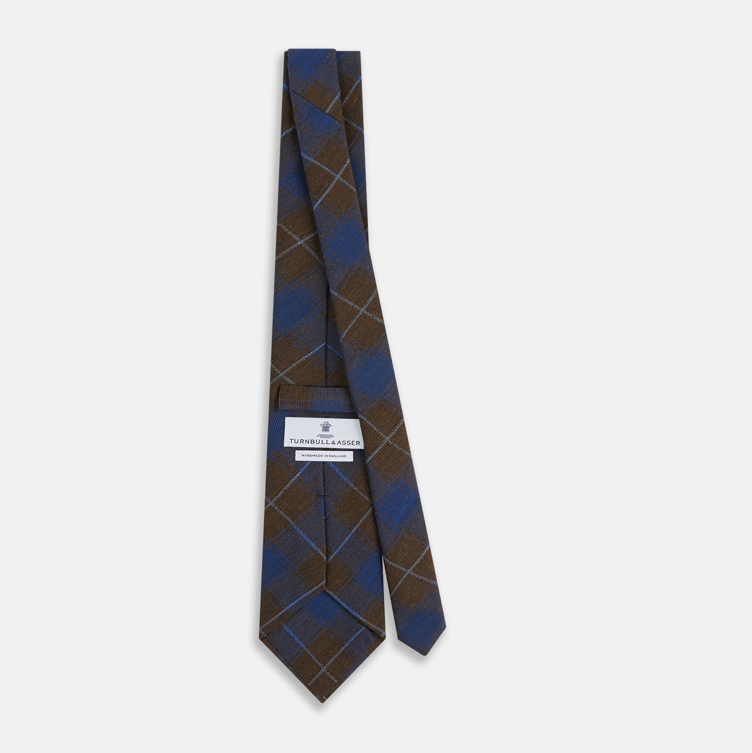 Image 4 of product The Turnbull & Asser Blue and Brown Tartan Silk Blend Tie, rolled up to show intersecting patterns, is displayed against a plain white background.